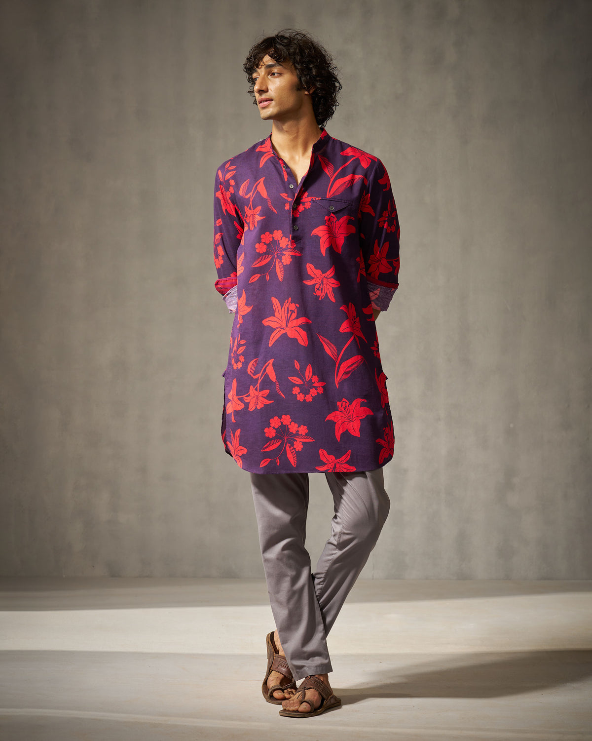 Person wearing a purple Fort Kurta with a red floral print.
