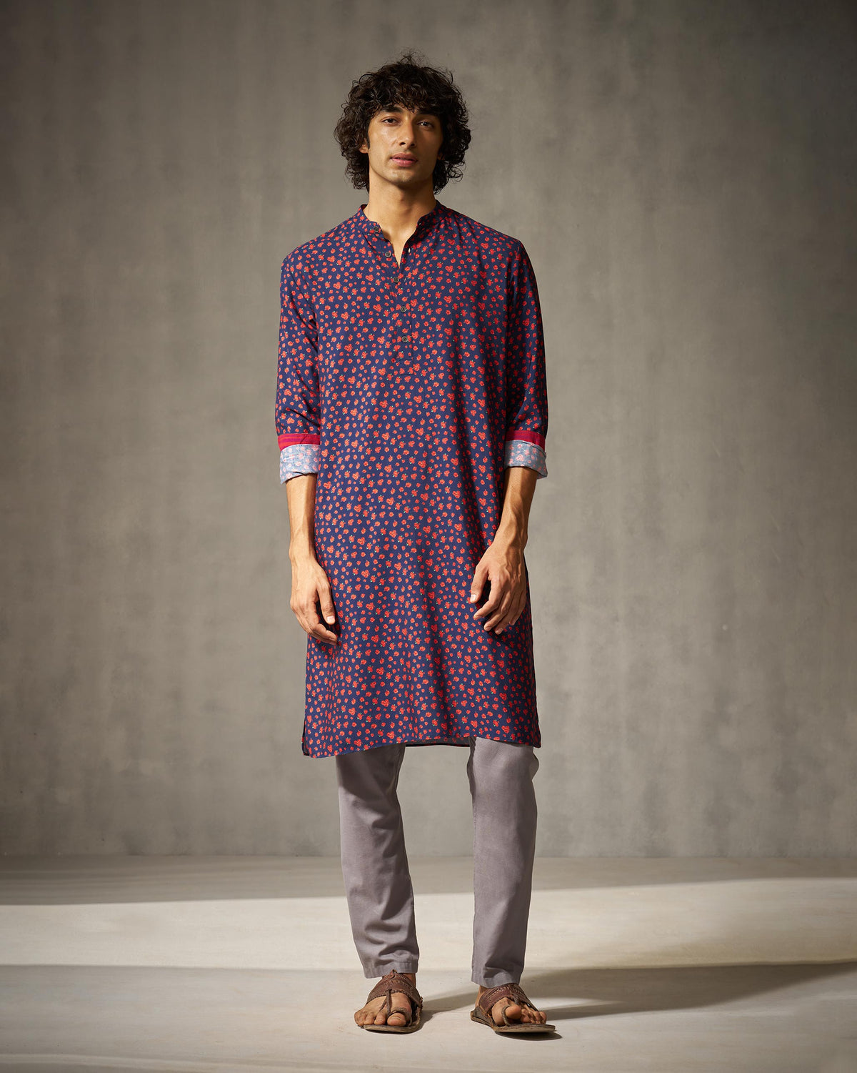 Person wearing a navy Bageecha kurta with an all-over red rose print.