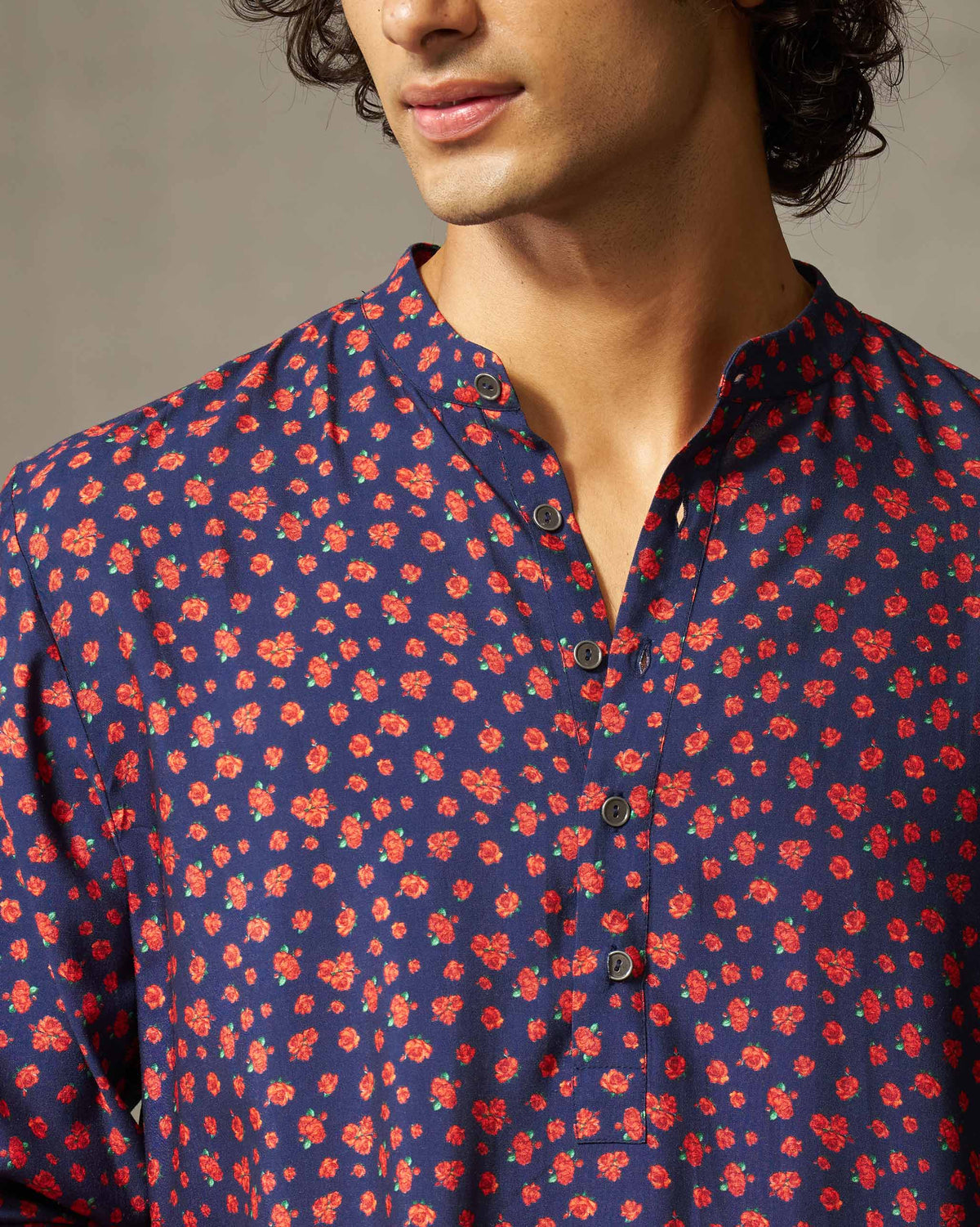 Close-up of a navy Bageecha kurta showing the mandarin collar and rose print.
