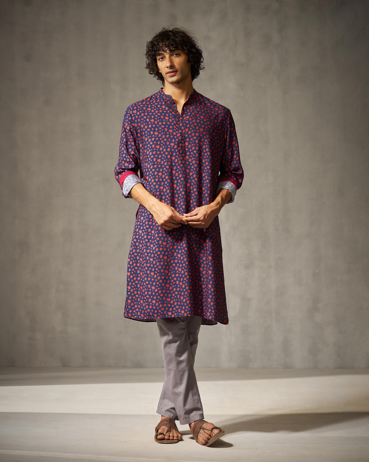 Person wearing a navy Bageecha kurta with red print and contrasting cuffs.