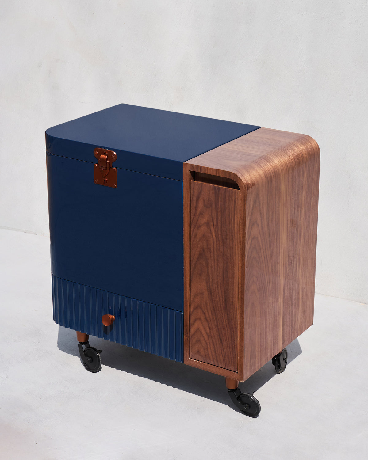 Closed Contours of Time bar trolley in navy with a curved wood side panel.