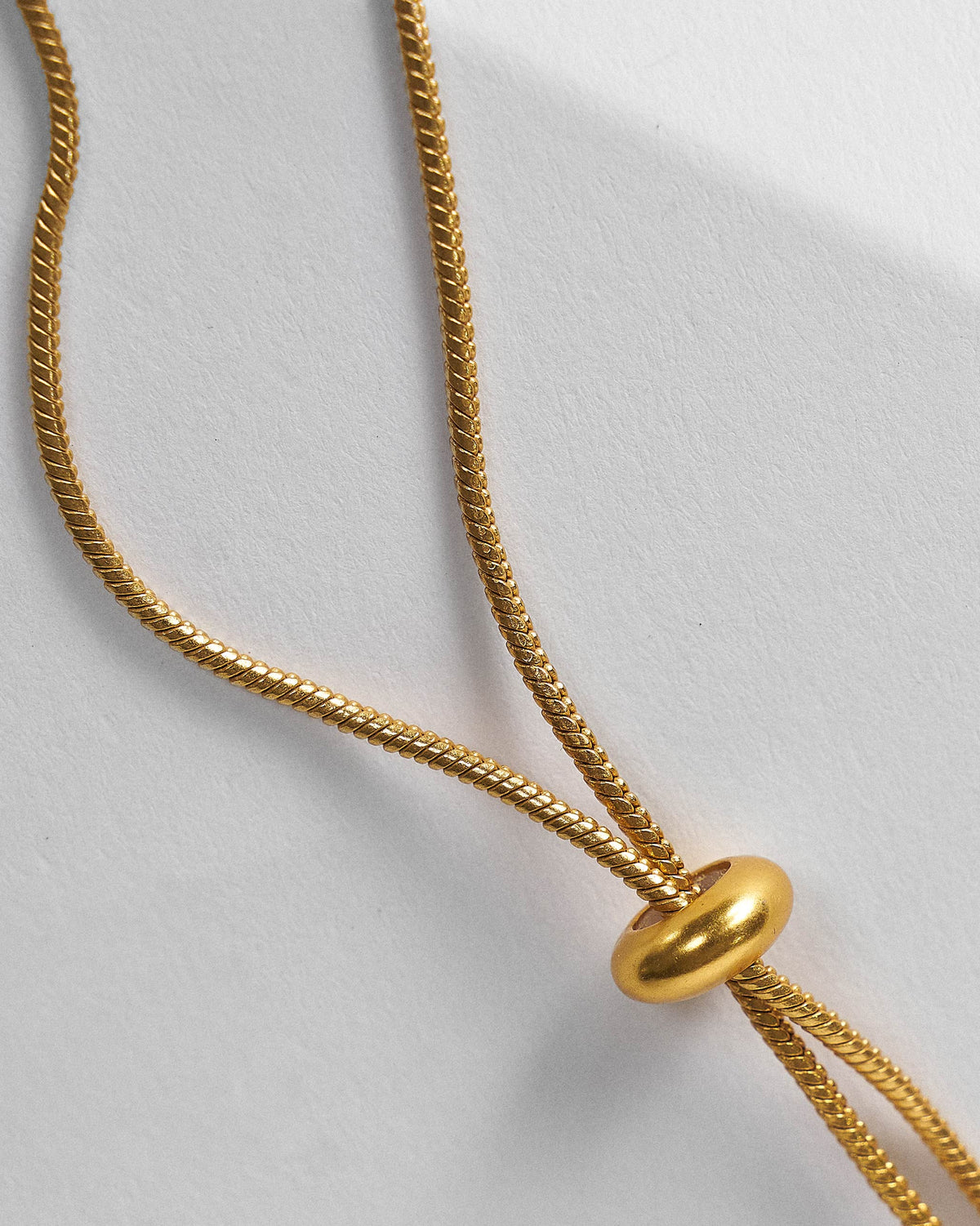Close-up of the Berber necklace gold adjustable slider closure.