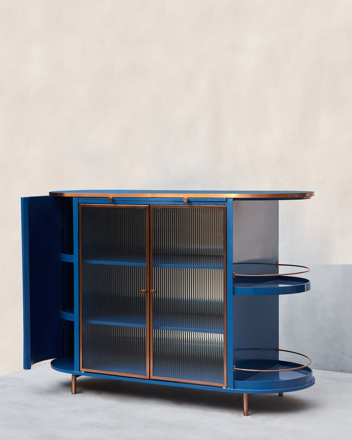 Contours of Time cabinet with a side door open to curved blue shelves.