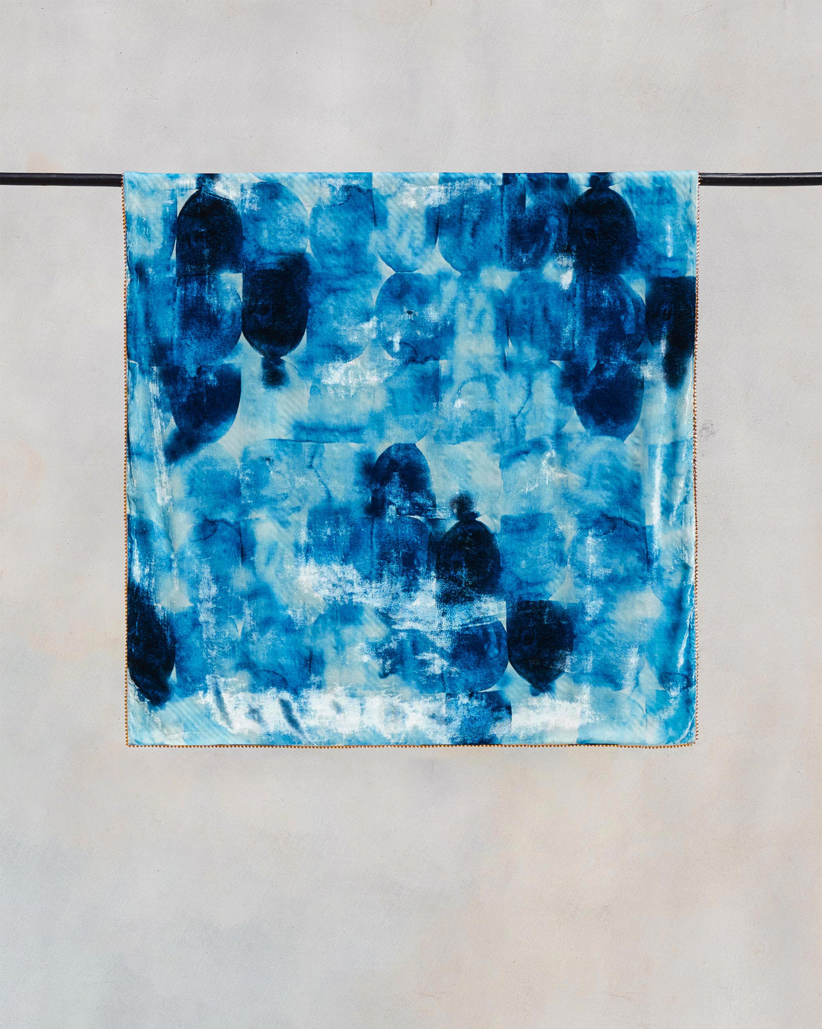 Pacific throw in blue and white with a dark blotched pattern.