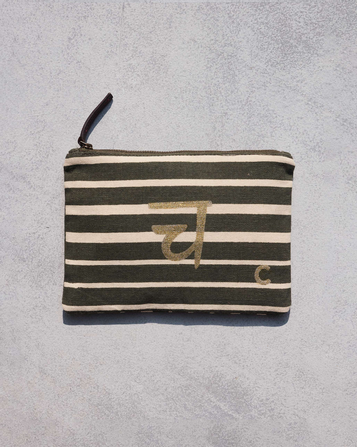 Olive and cream striped Alphabet C Pouch with a gold letter motif.