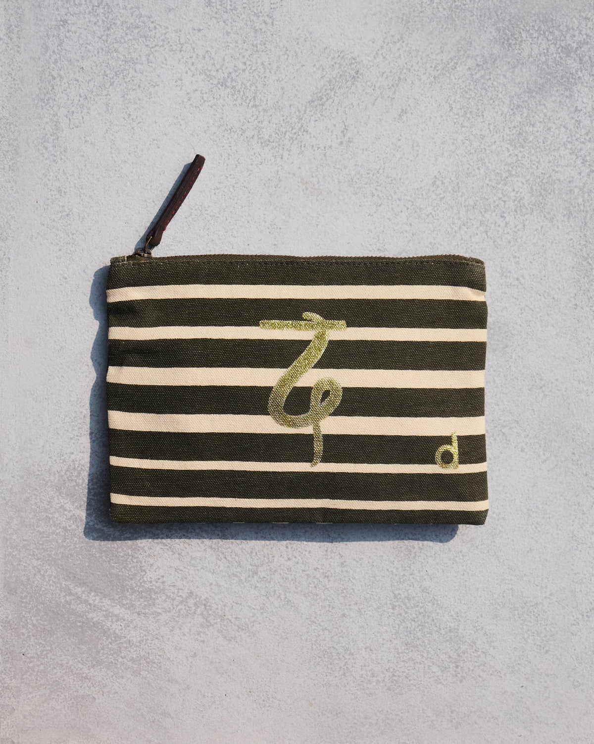 Olive and cream striped Alphabet D Pouch with a gold letter motif.