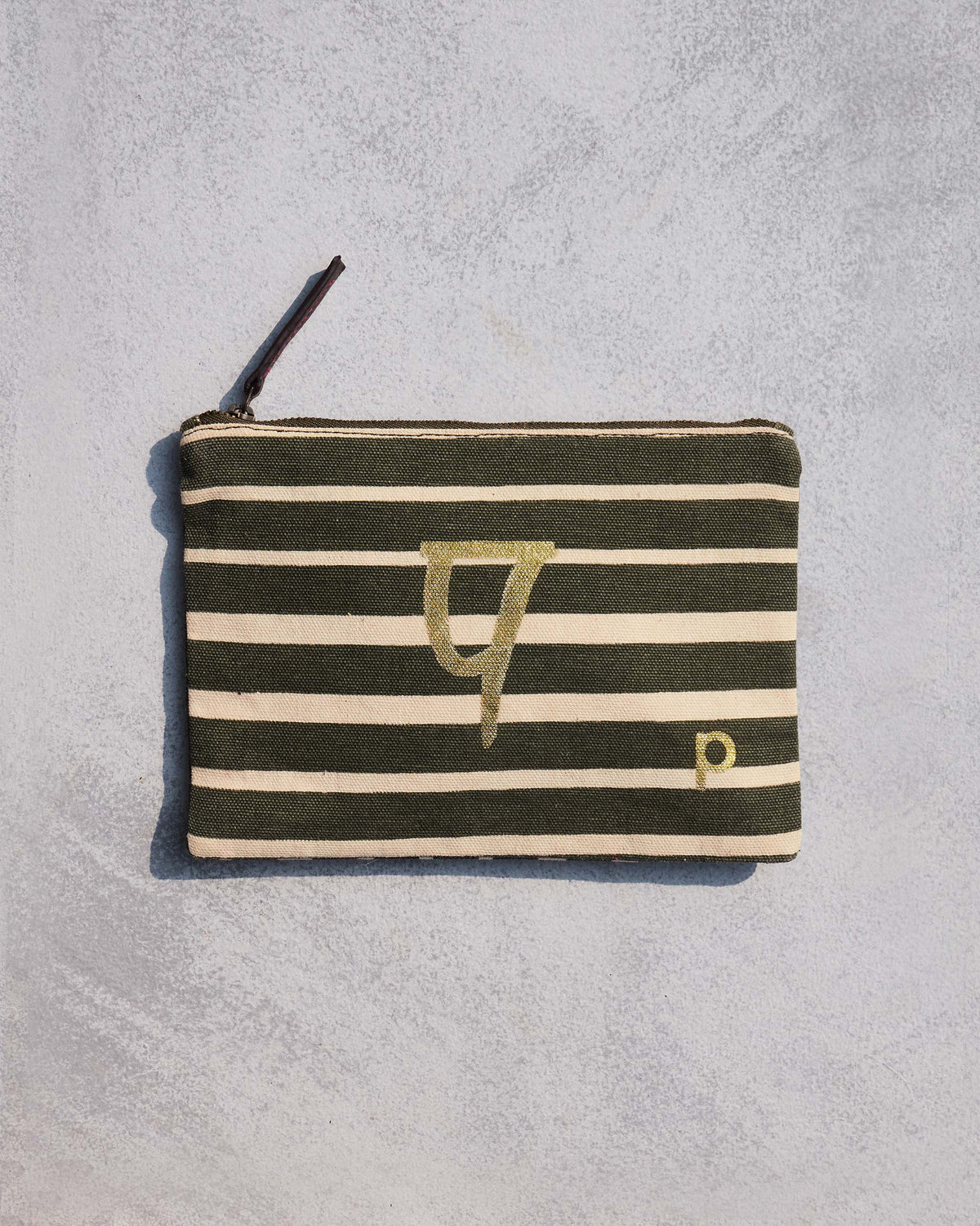 Alphabet P Pouch in olive and cream stripes with a gold script letter.