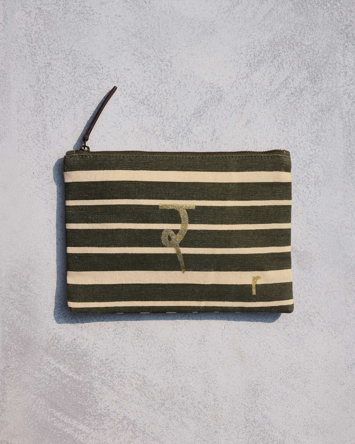Alphabet R Pouch in olive and cream stripes with a gold script letter.