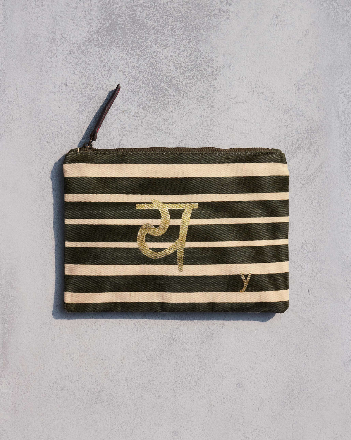 Alphabet Y Pouch in olive and cream stripes with a gold script letter.