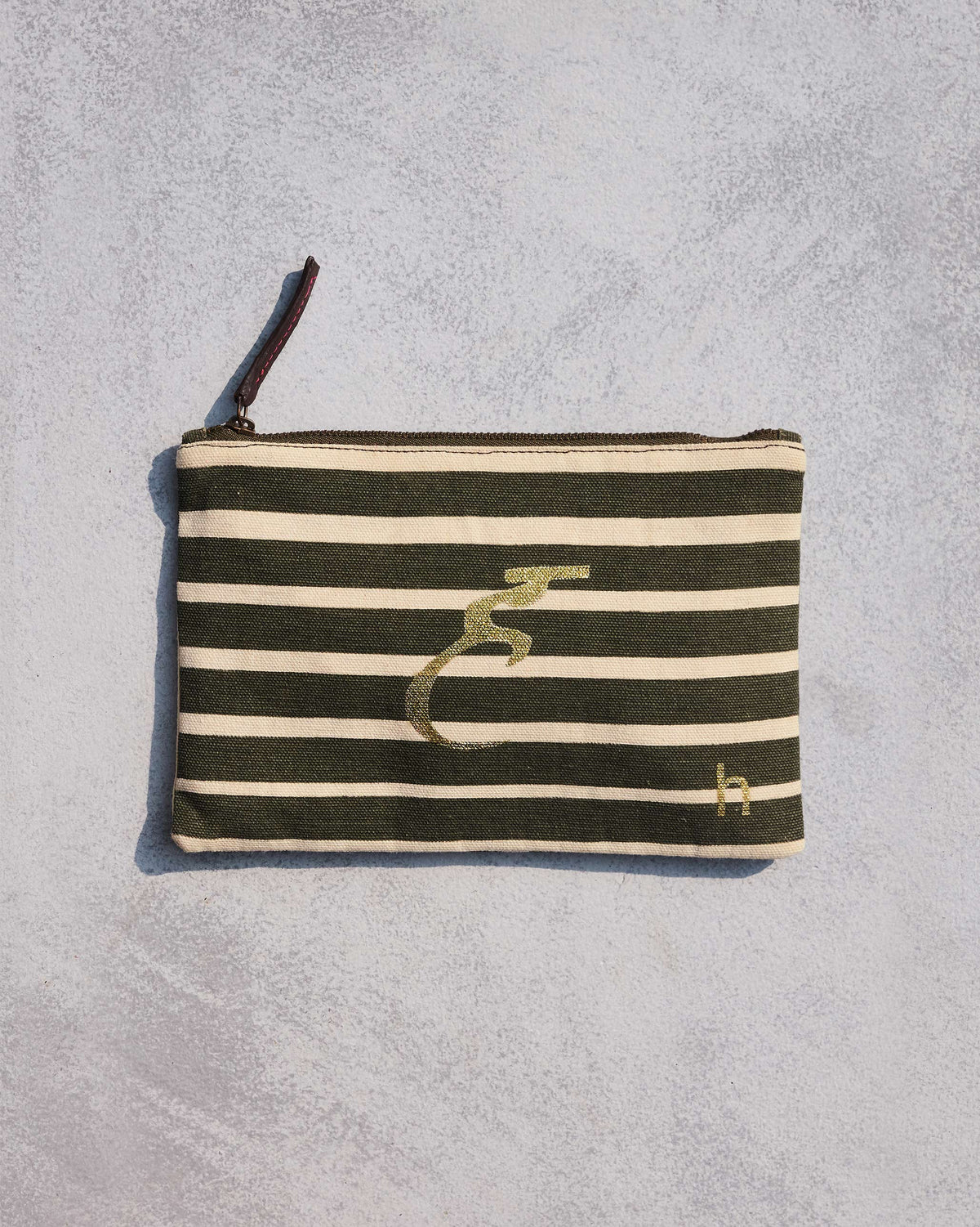 Alphabet H Pouch in olive and cream stripes with a gold script letter.