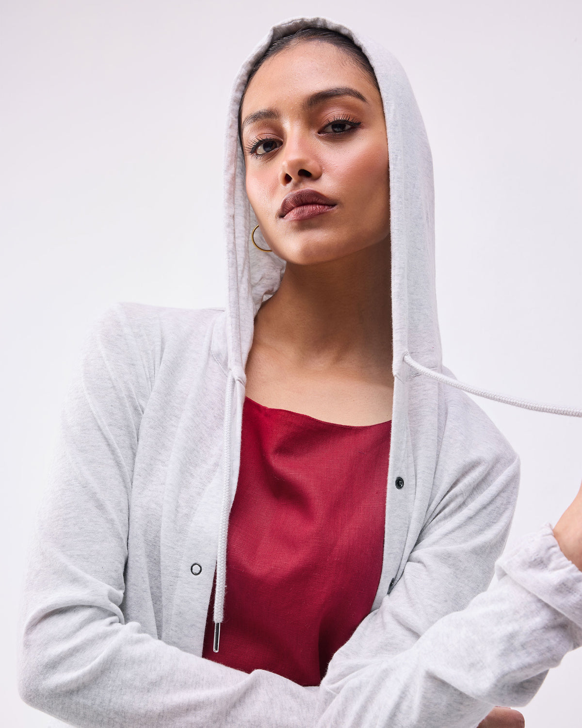 Close-up of a grey Airport Hoodie with the hood up and drawstrings.