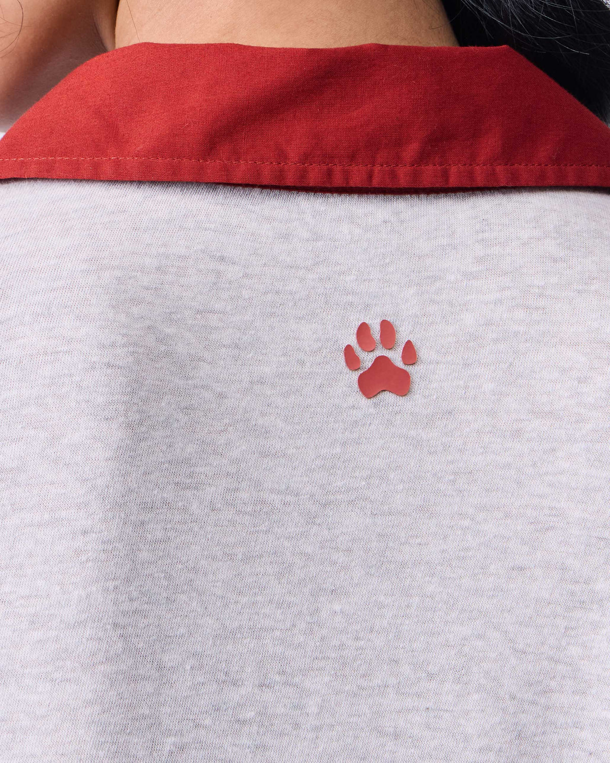 Close-up of a grey Autumn Dress back showing a red tiger paw embroidery.