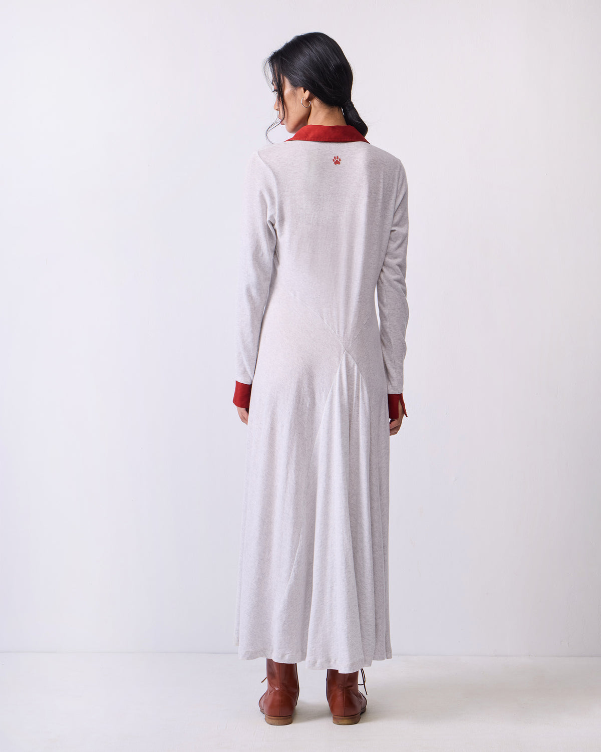 Back of a grey Autumn Dress with a red tiger paw at the upper back.