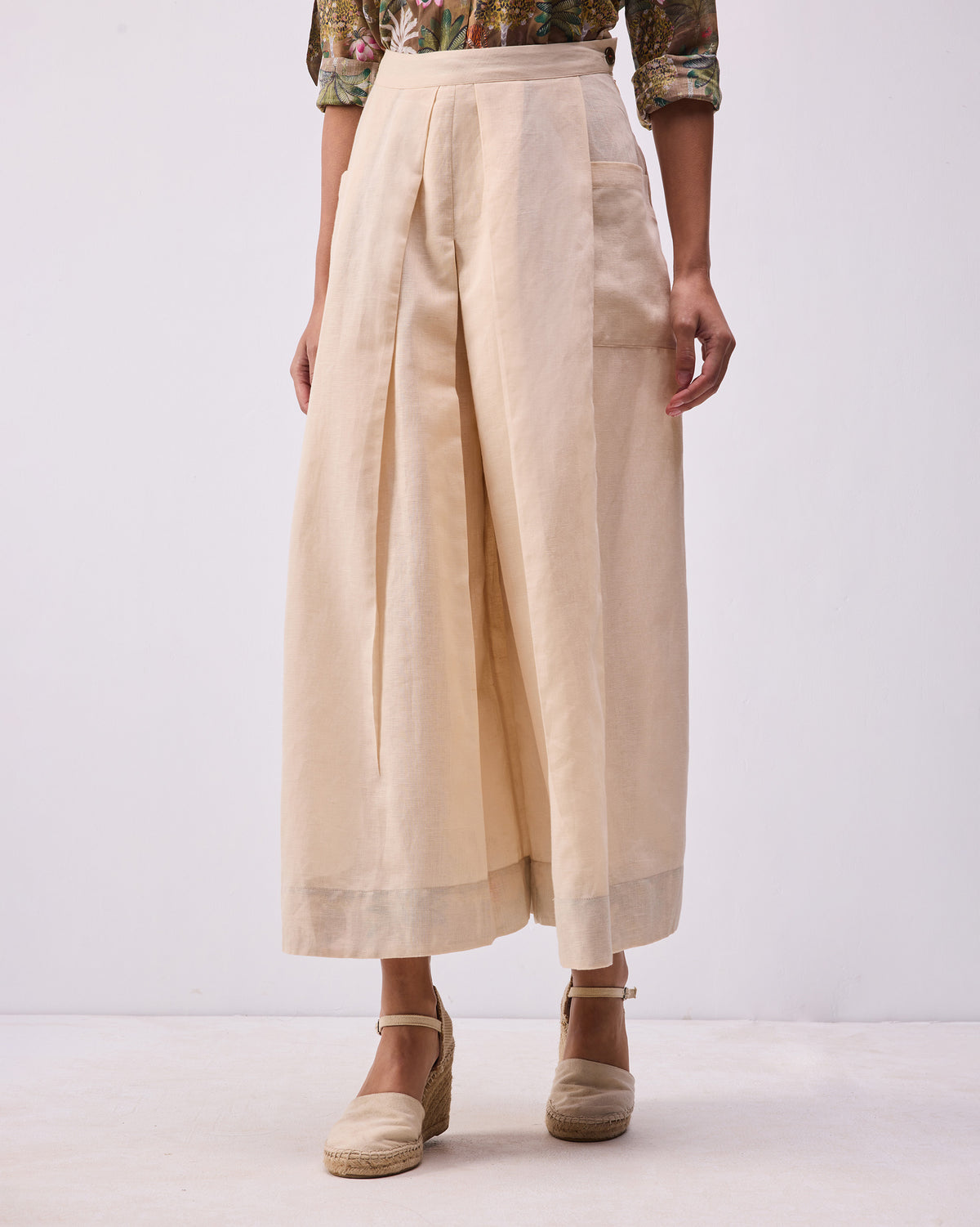 Person wearing a beige Pocket skort with wrap front pleats.