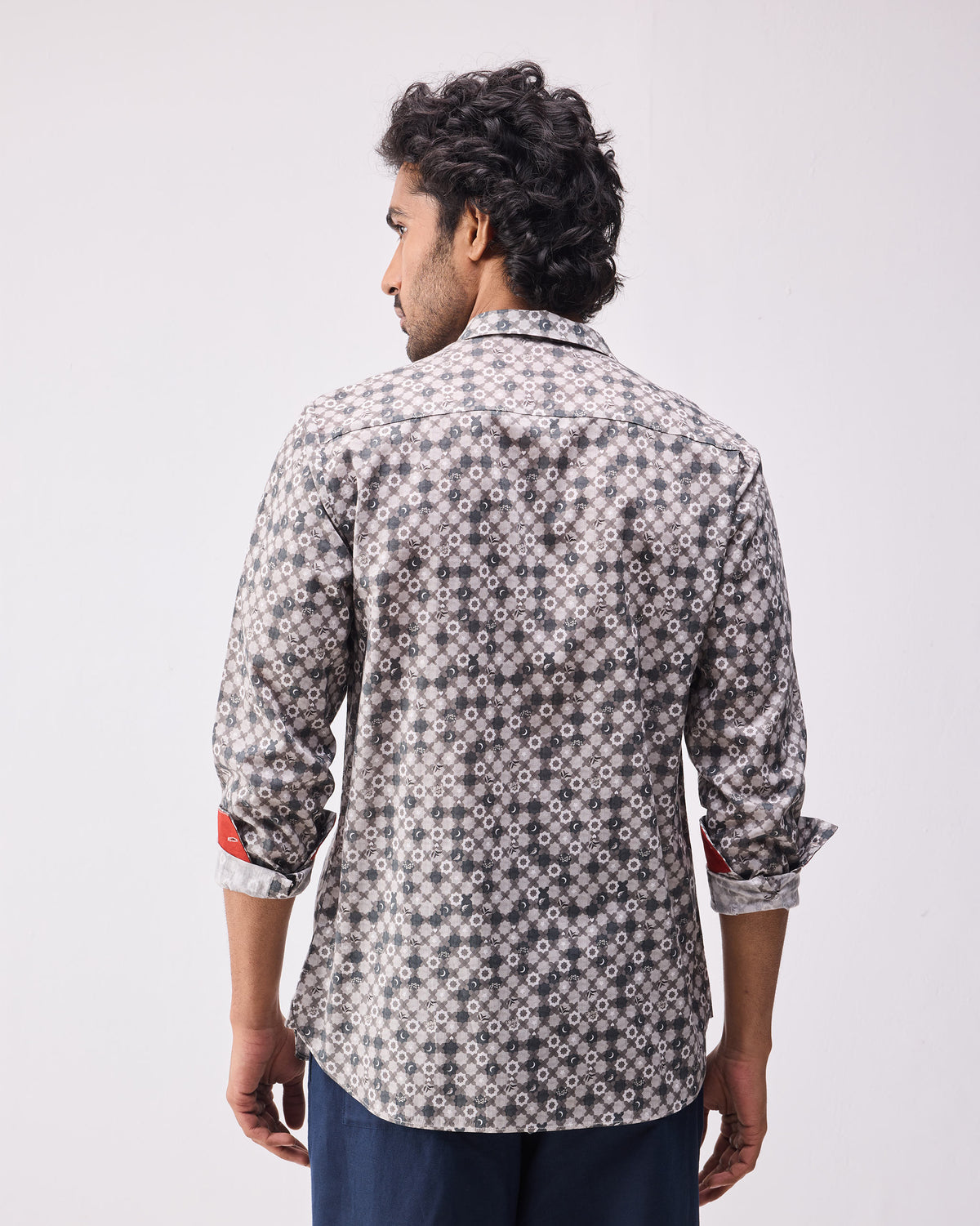 Back of a light grey print Kochi shirt with red cuff lining.