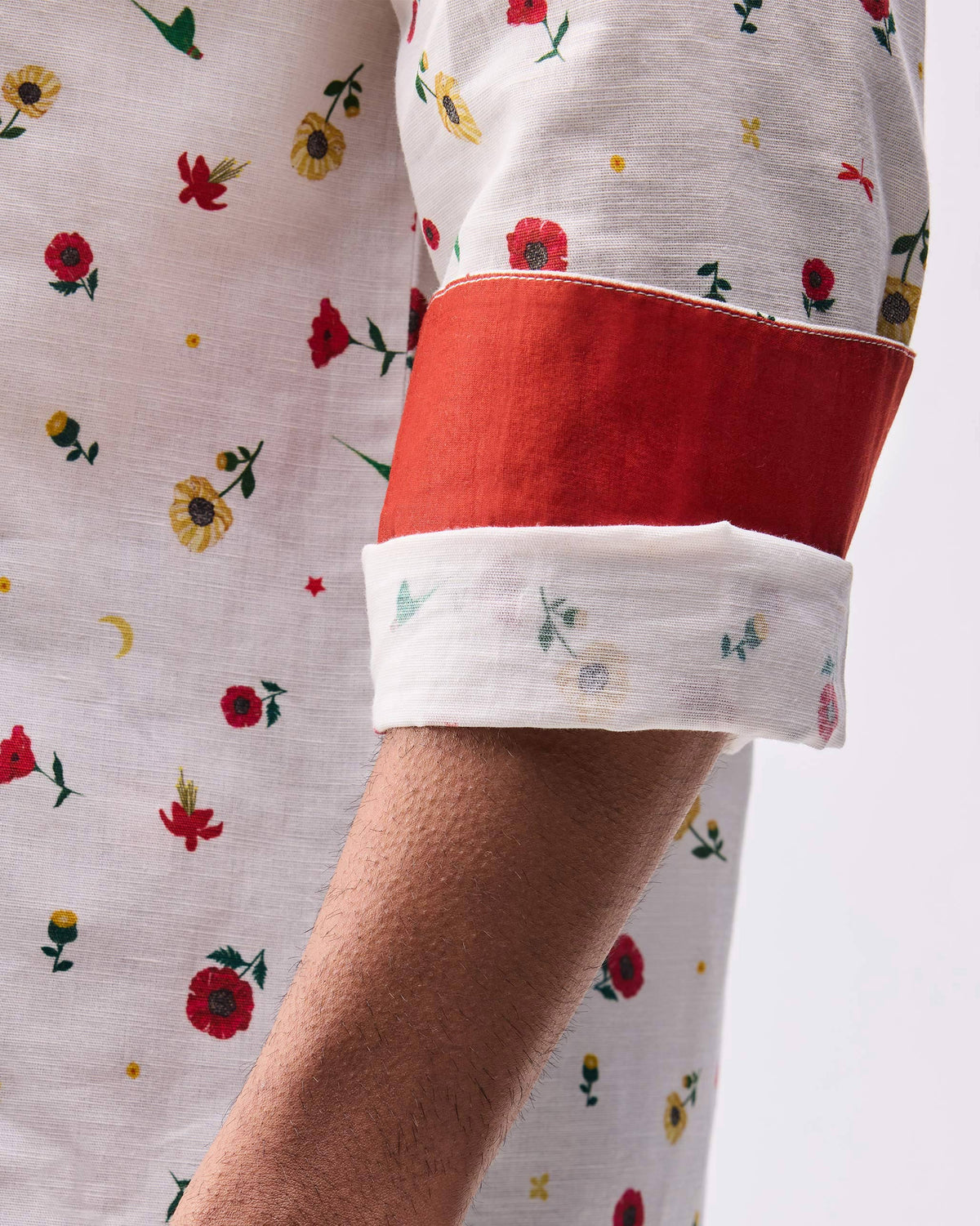 Close-up of a Catamaran shirt sleeve rolled to show solid red cuff lining.