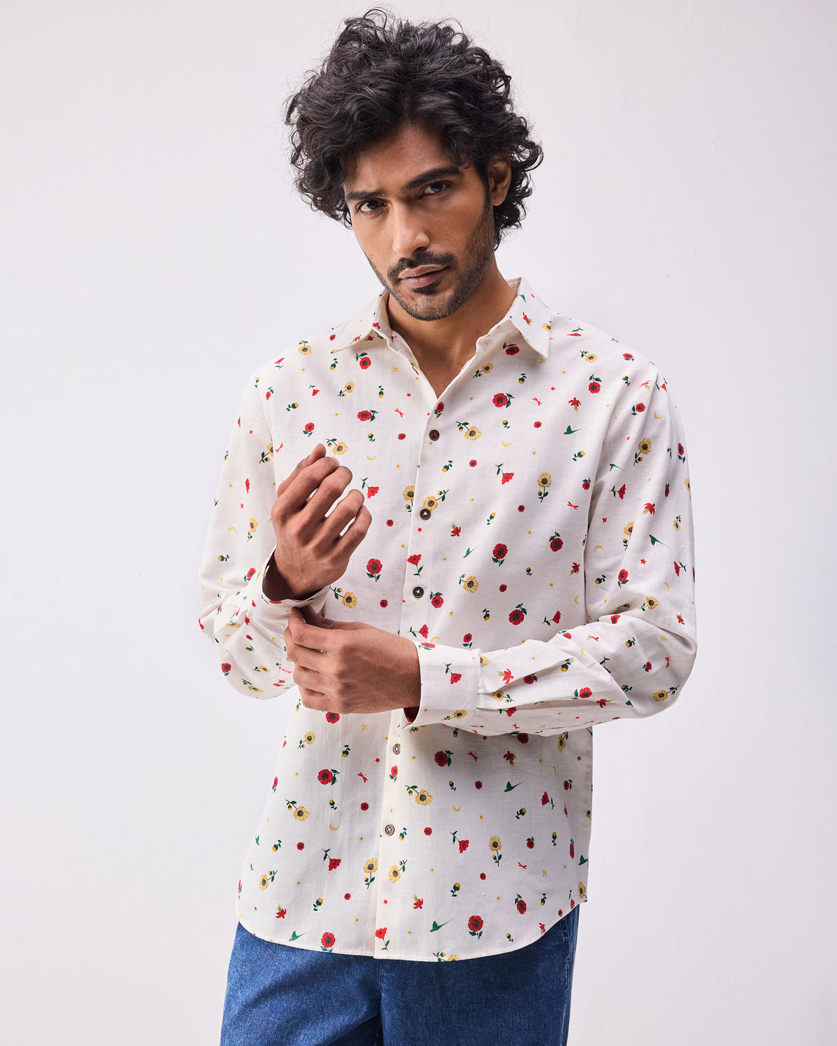 Person wearing an ivory Catamaran shirt with a small floral print.