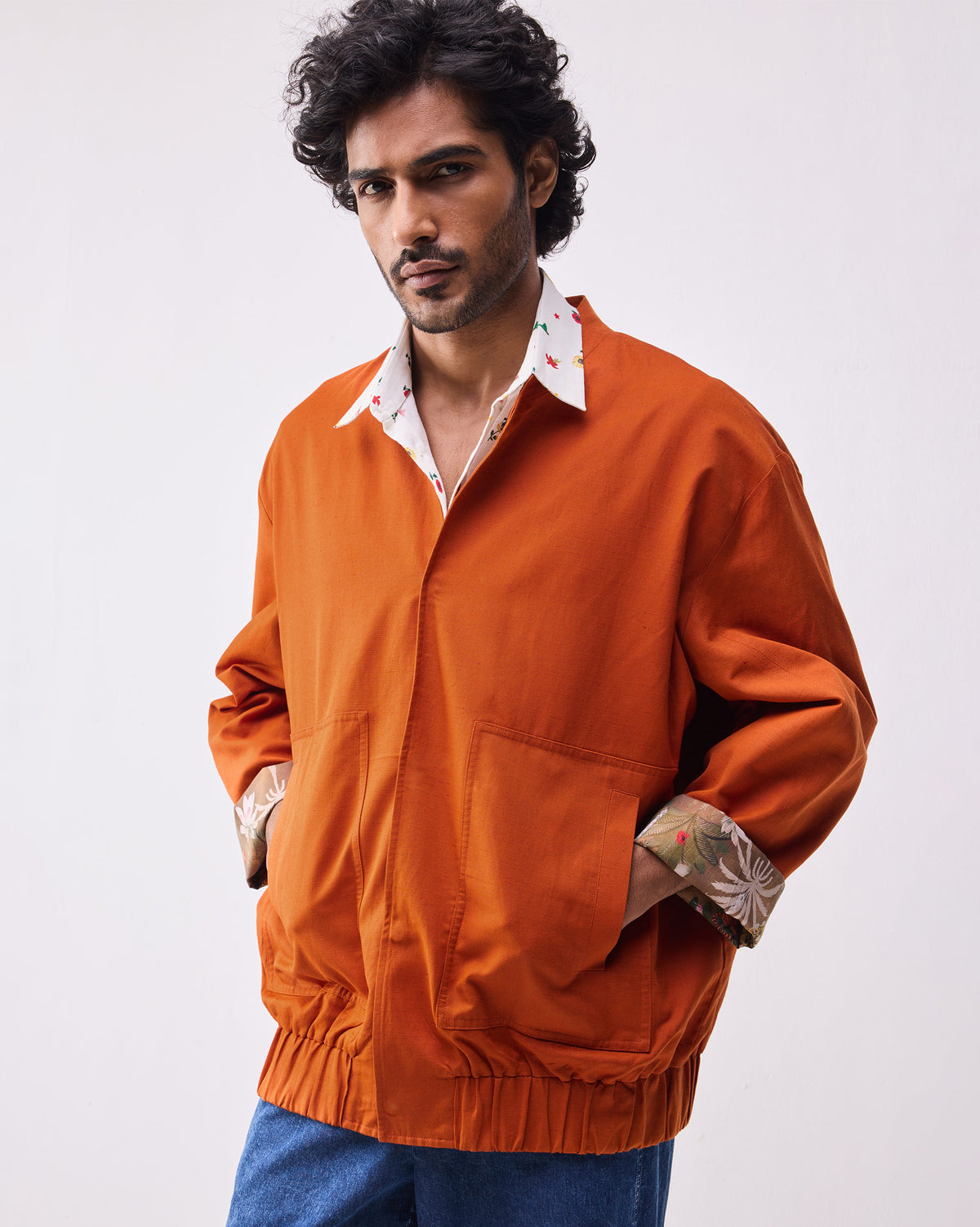 Rust Safar bomber with patch pockets and botanical cuff lining.