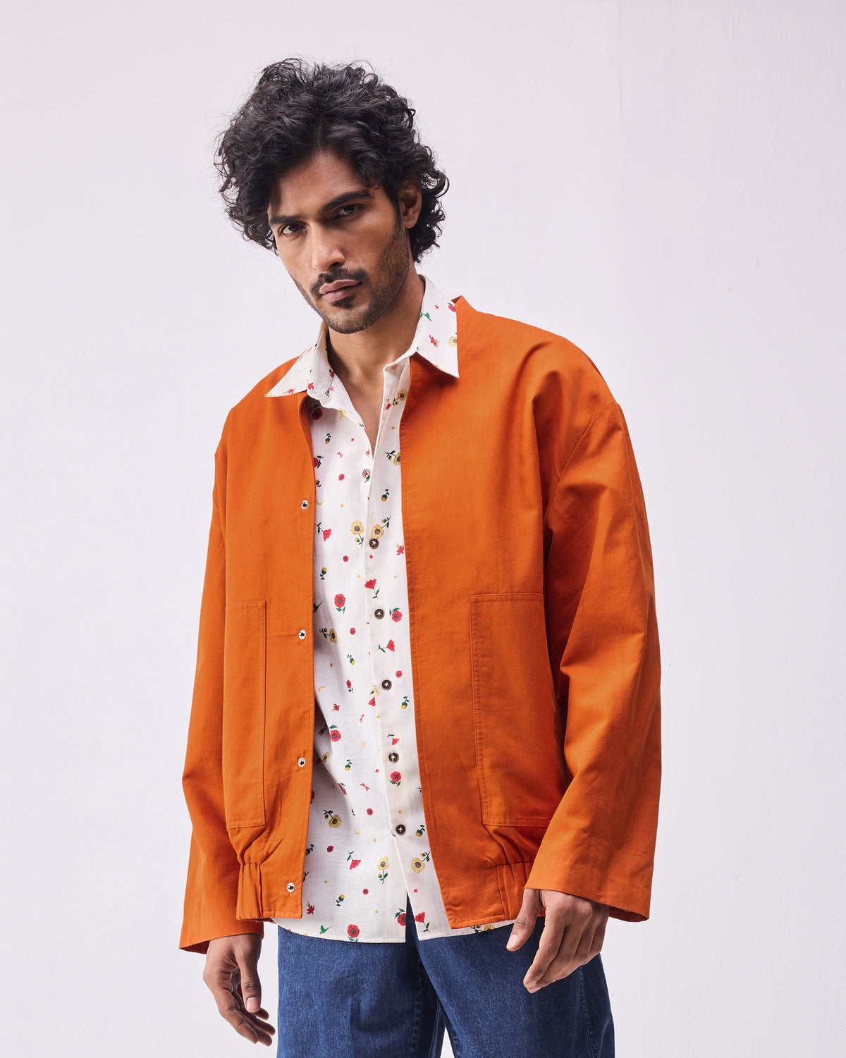 Rust Safar bomber with snap buttons and patch pockets.