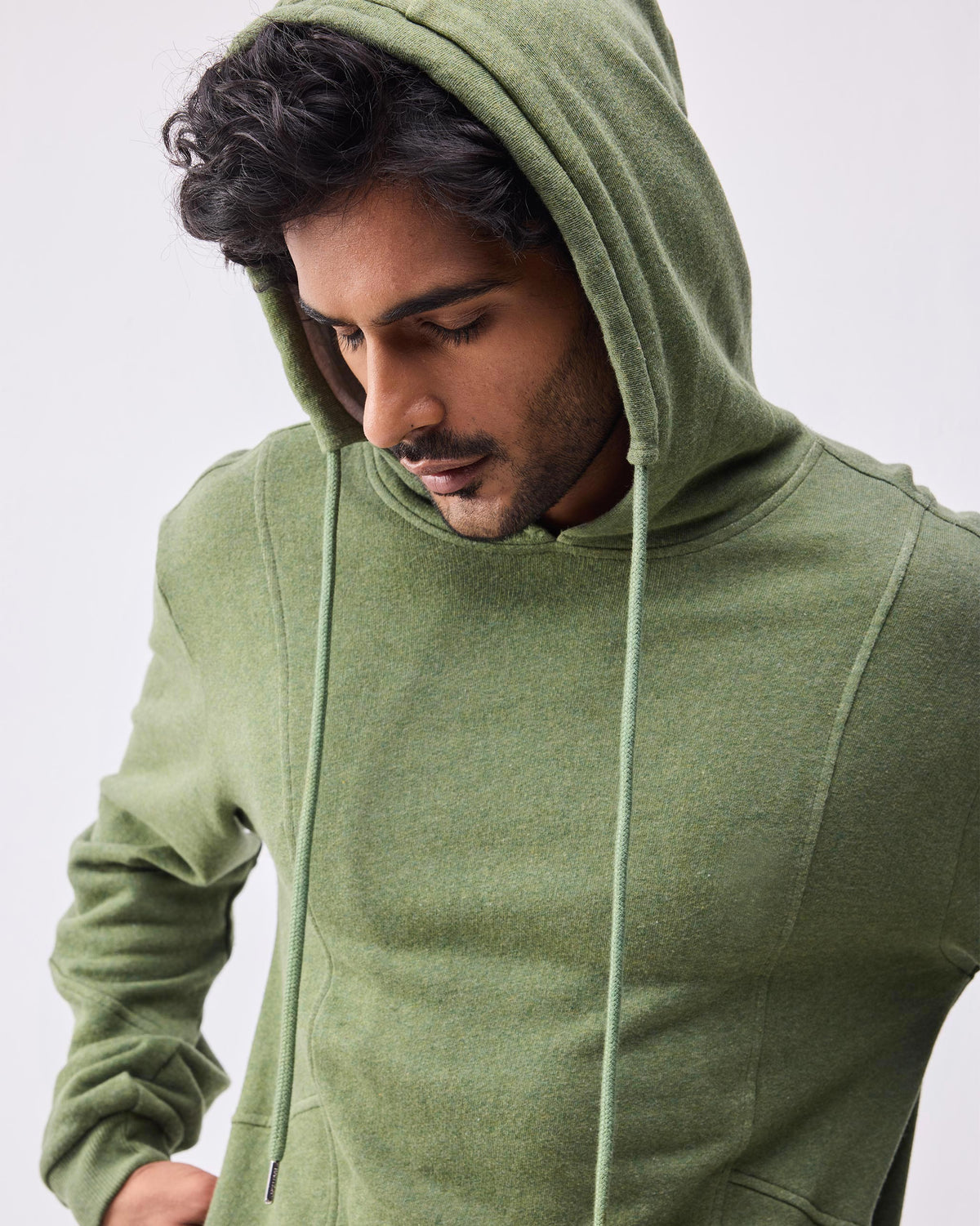 Olive green Urban Sweatshirt with the hood worn up.