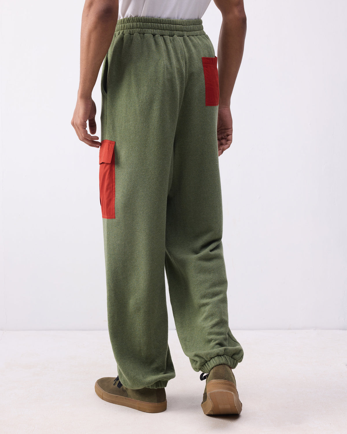 Back of green Lounge Pants with red patch pockets on the seat and thigh.