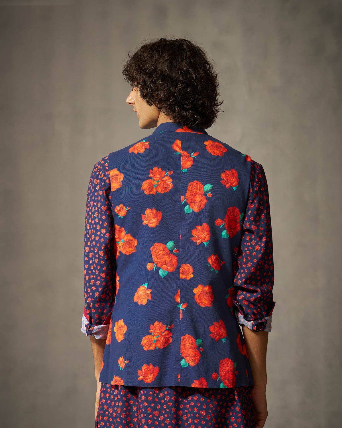Back of a navy Nehru jacket with an all-over red rose print.