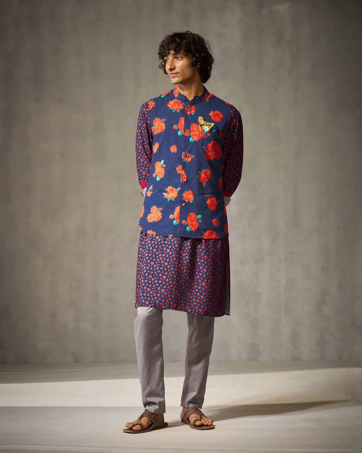 Person wearing a navy red rose Nehru jacket over a patterned kurta.