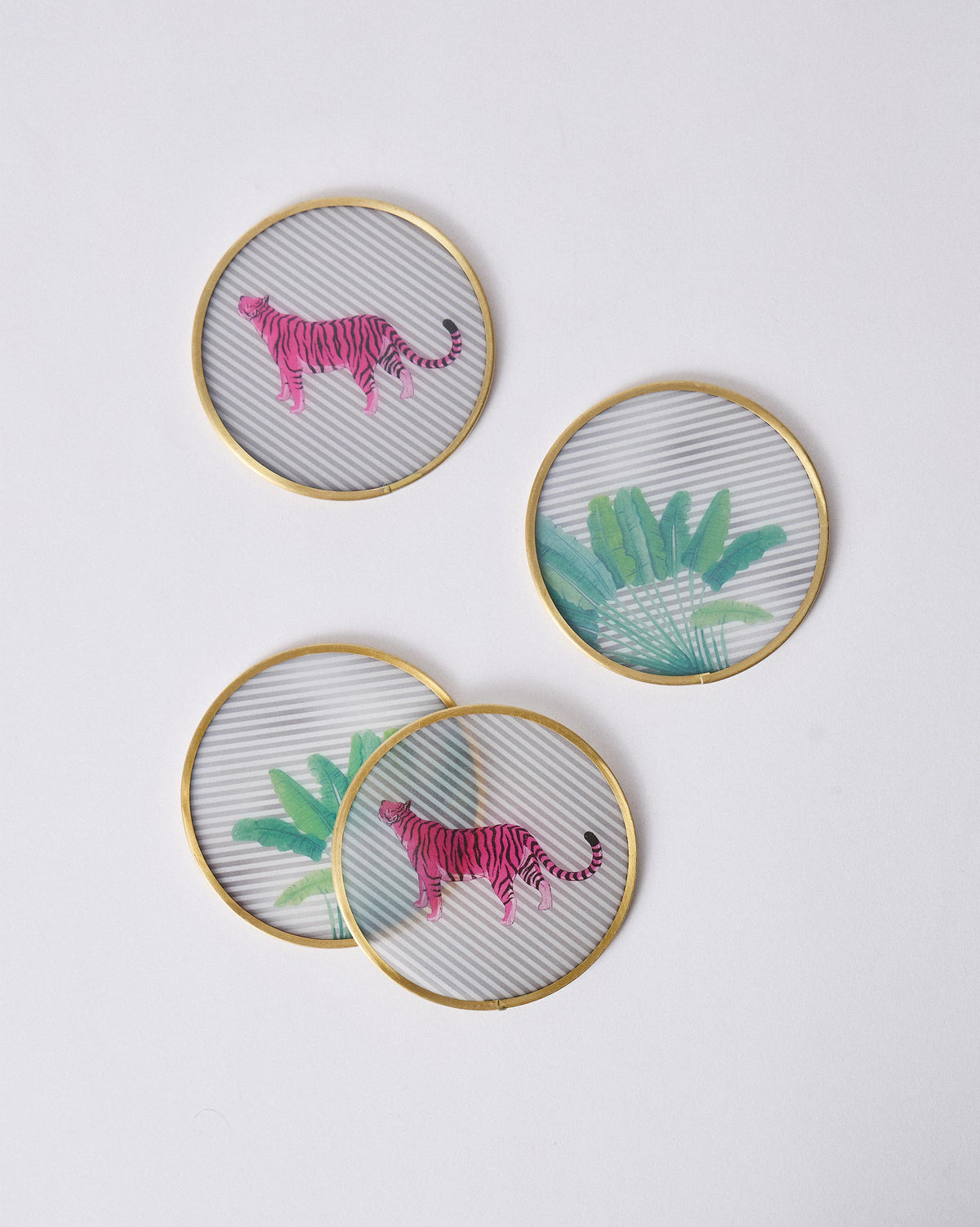 Ceylon Trail glass coasters with pink tiger and tropical leaf motifs.
