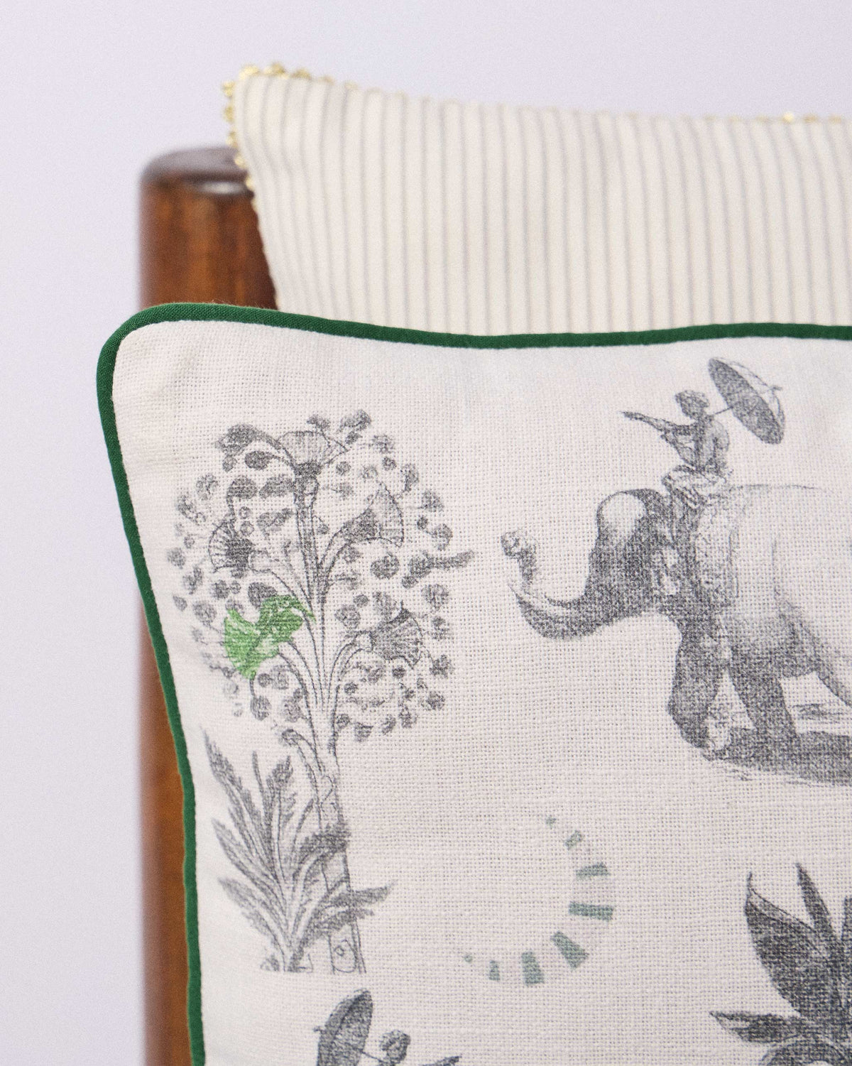 Close-up of Ceylon Trail Cushion Cover showing an elephant with a rider under an umbrella.
