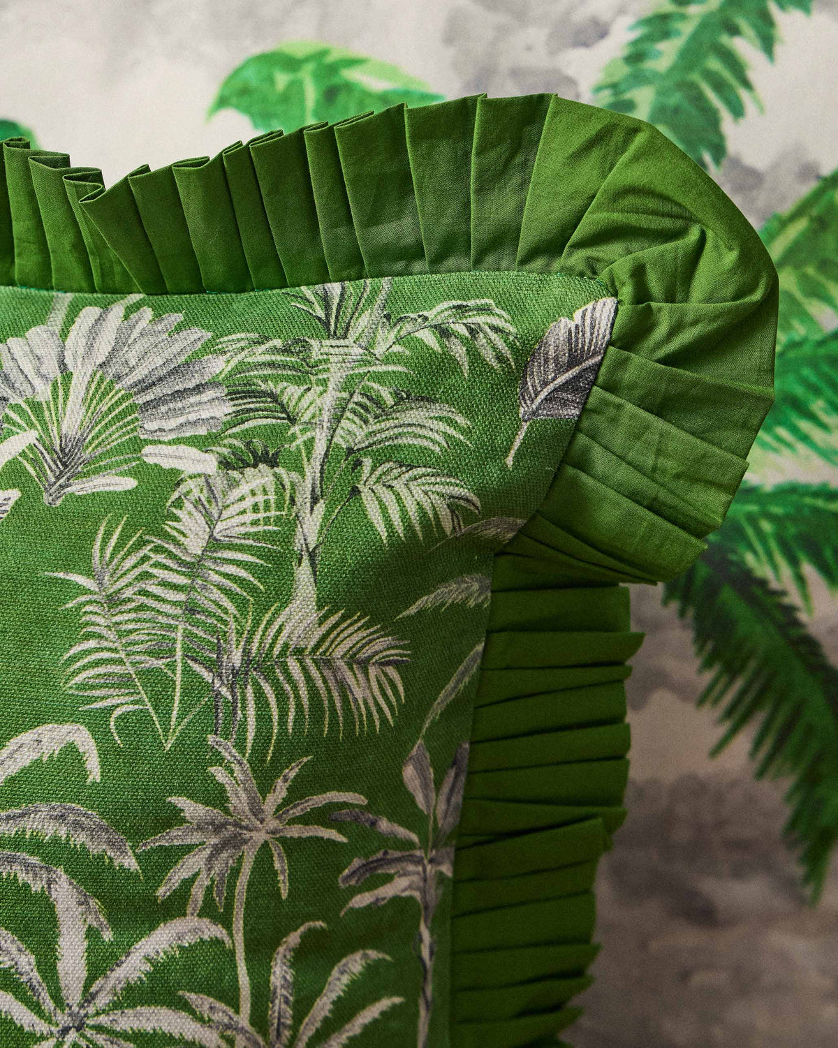 Close-up of the Palm Trail cushion's green pleated ruffle edge.