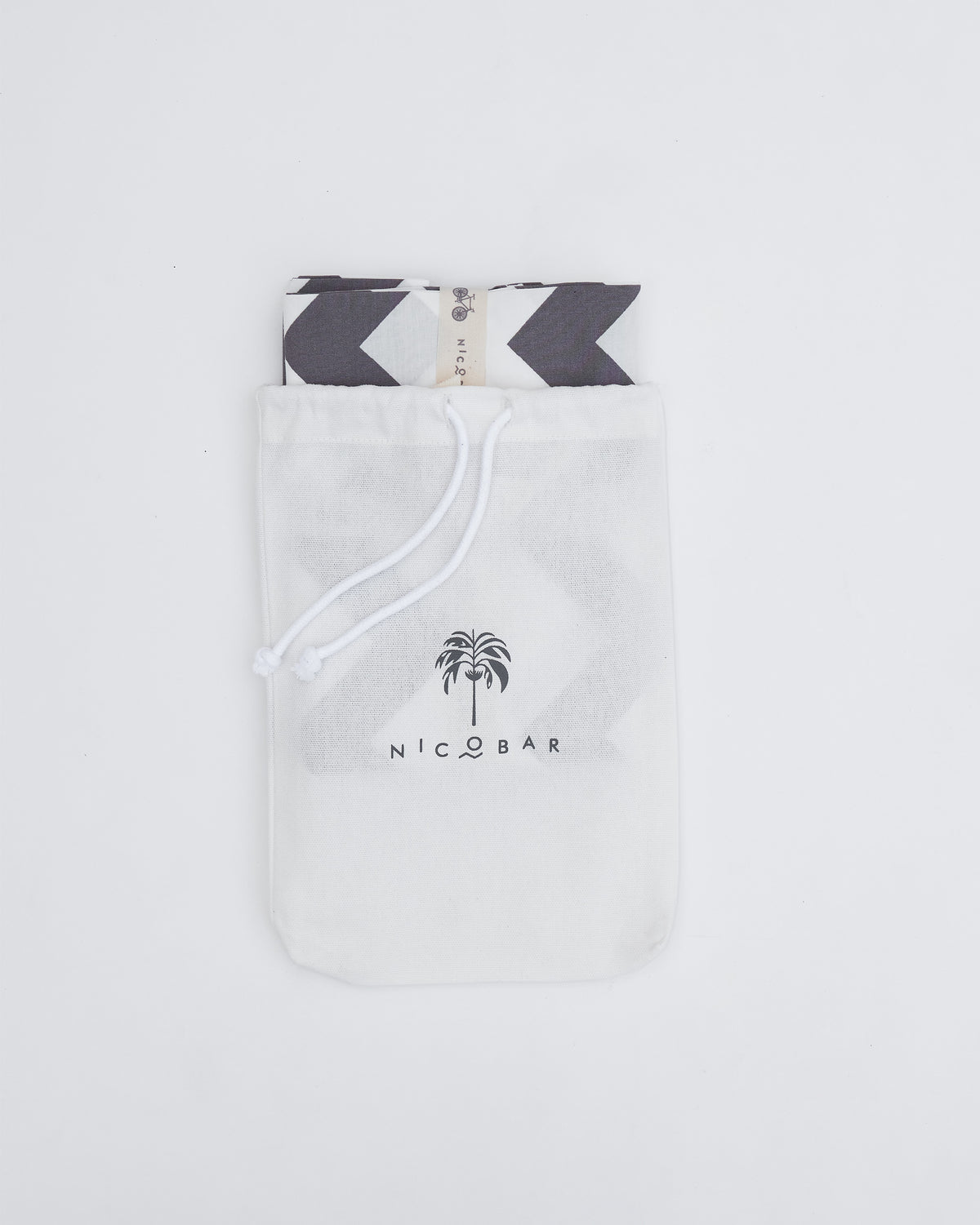 Grey and white Colombo Wave bedsheet packed in a Nicobar pouch.