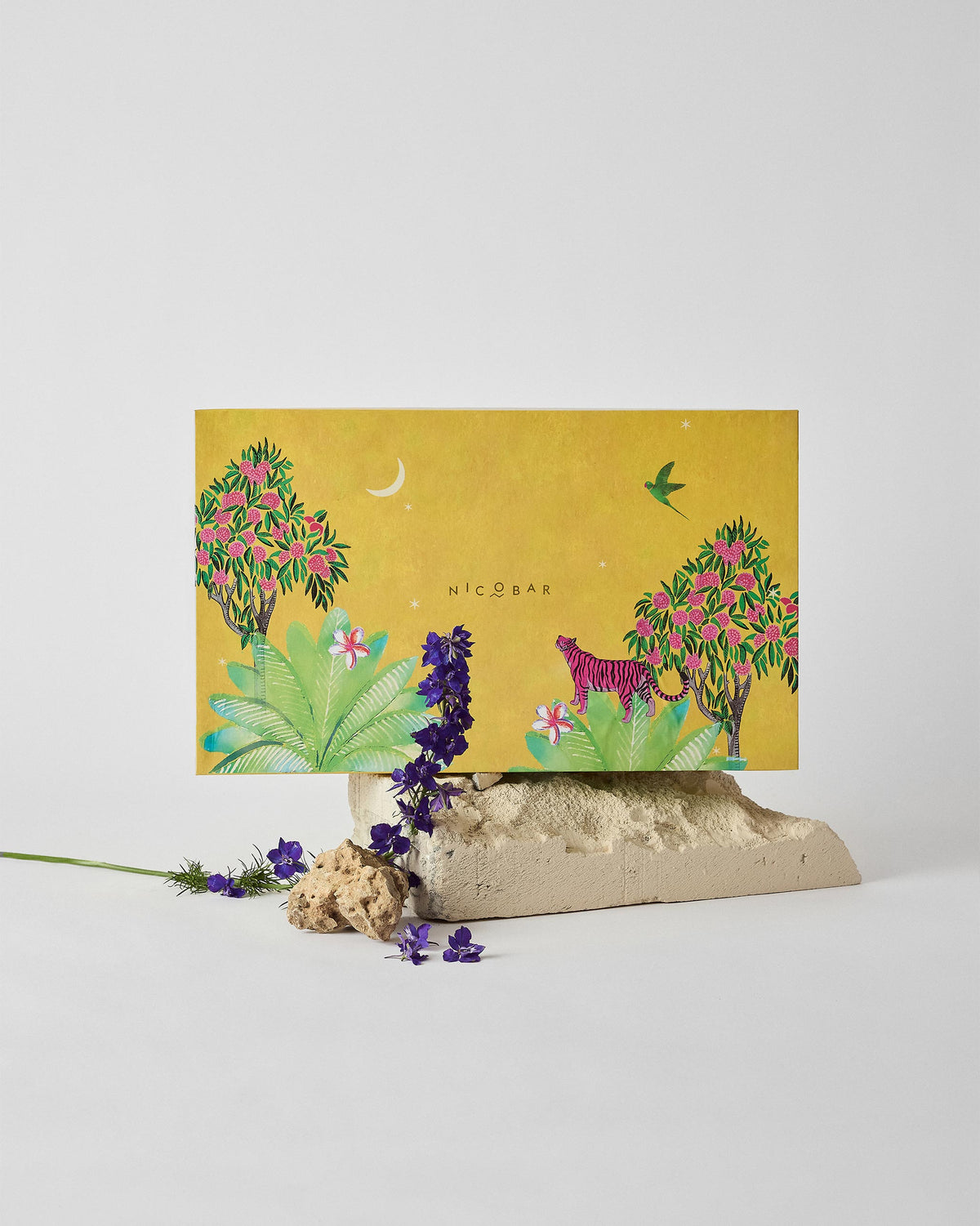 Nostalgia gift box with a pink tiger jungle illustration on mustard yellow.