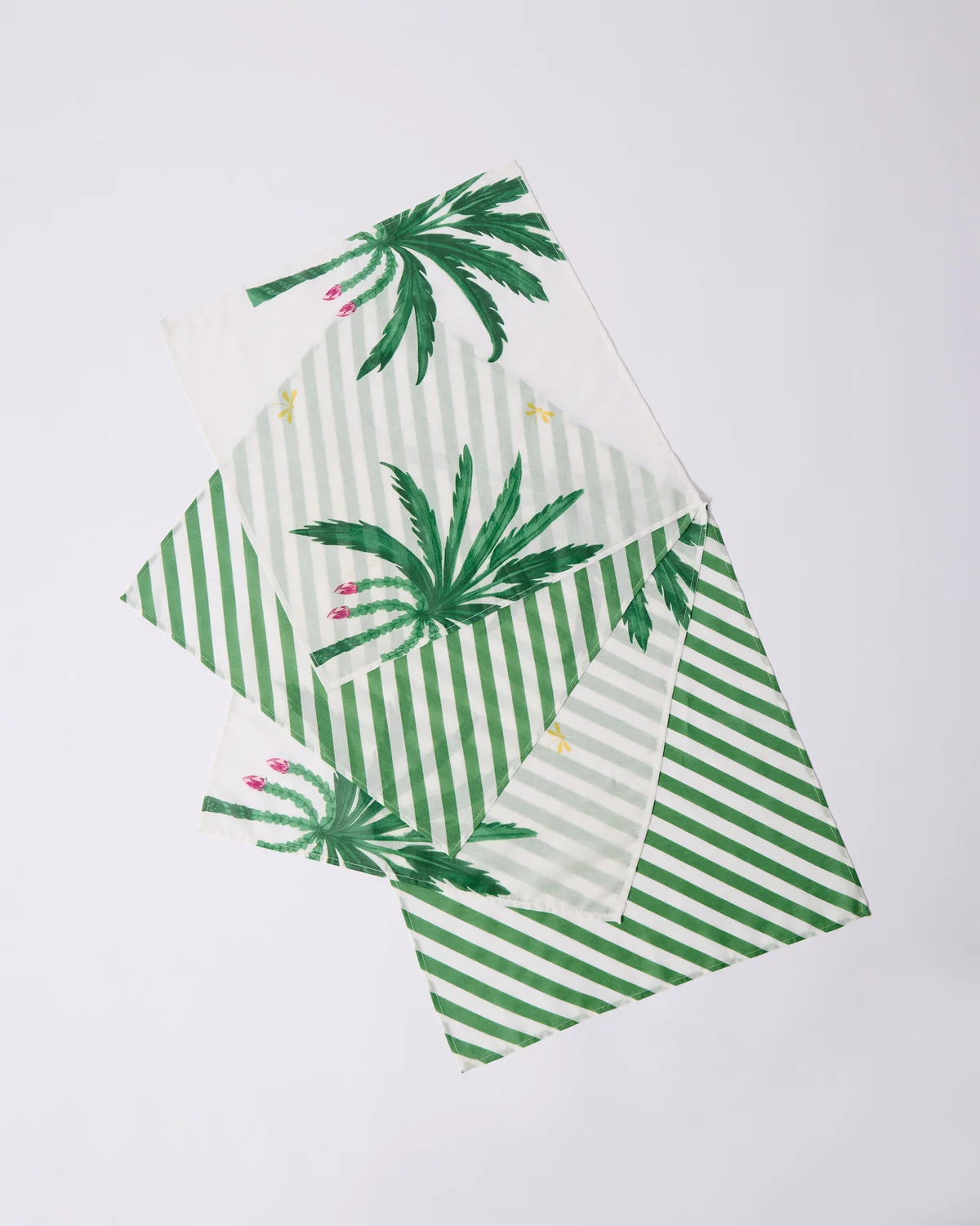 Ceylon Trail napkins with green palm print and diagonal stripes.