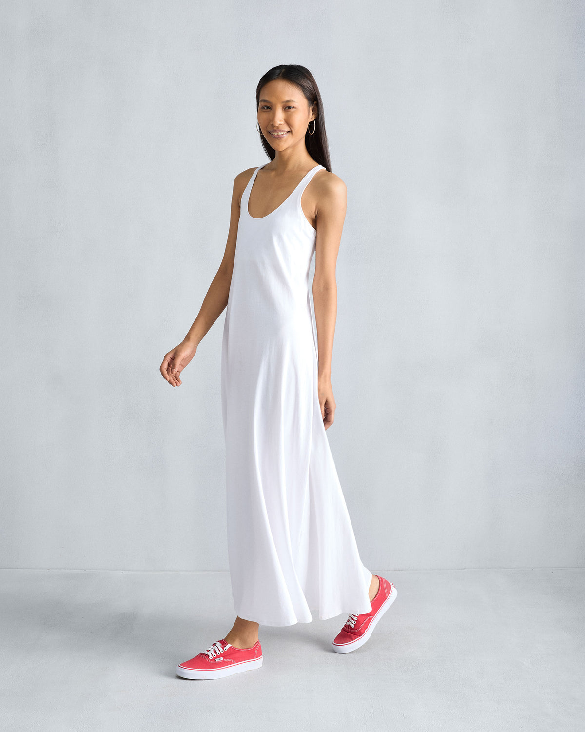 Side view of a white Esther dress showing the flowing A-line drape.
