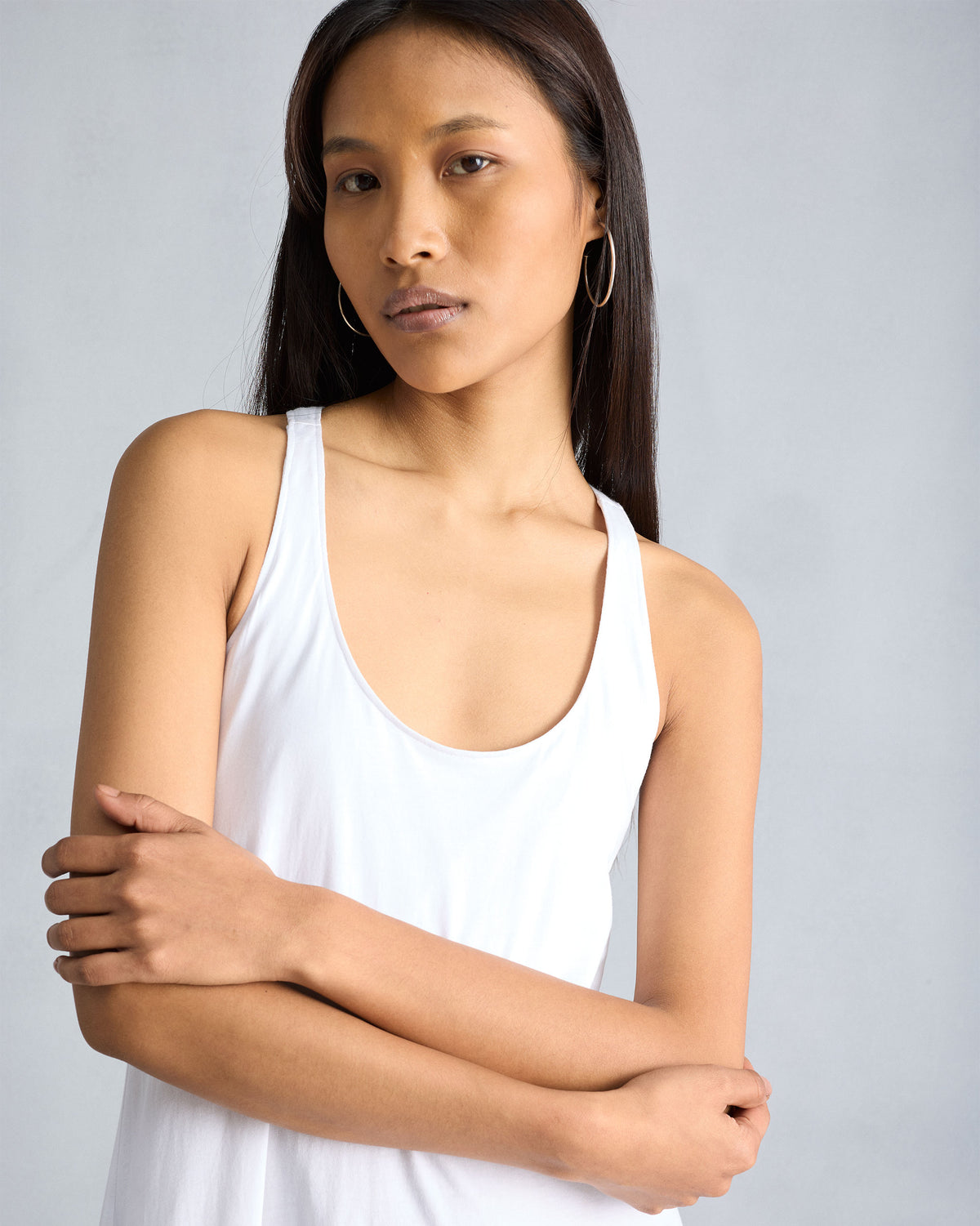 Close-up of the scoop neckline on a white Esther dress.