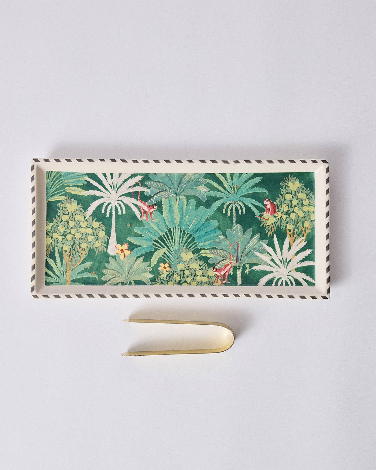 Ceylon Trail Cookie Tray with a brass tong beside it.