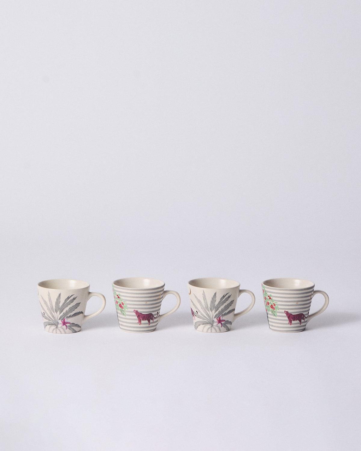 Set of four Ceylon Trail Espresso Mugs with palm and pink tiger prints.