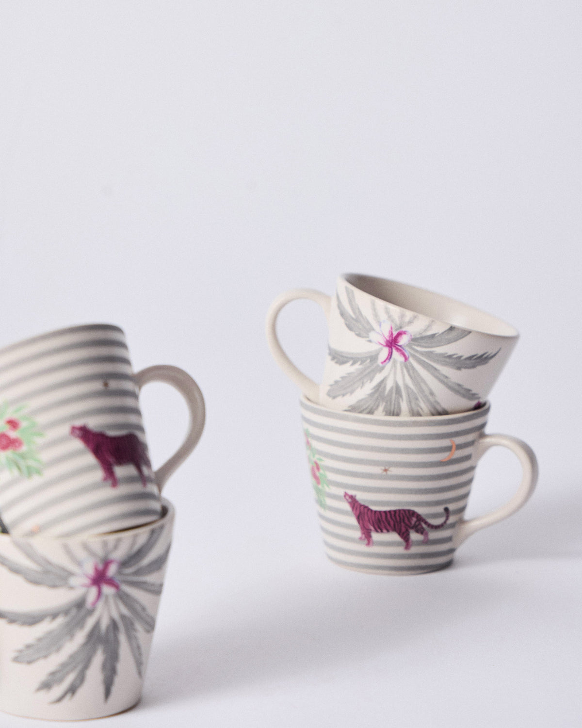 Ceylon Trail Espresso Mugs stacked in palm and pink tiger pairs.