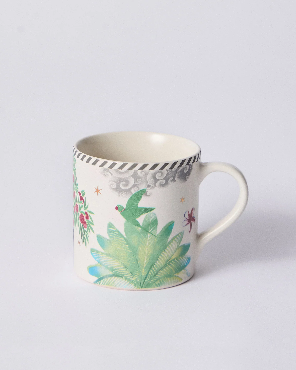 Side view of Ceylon Lush Straight Mug with a green bird over palm leaves.