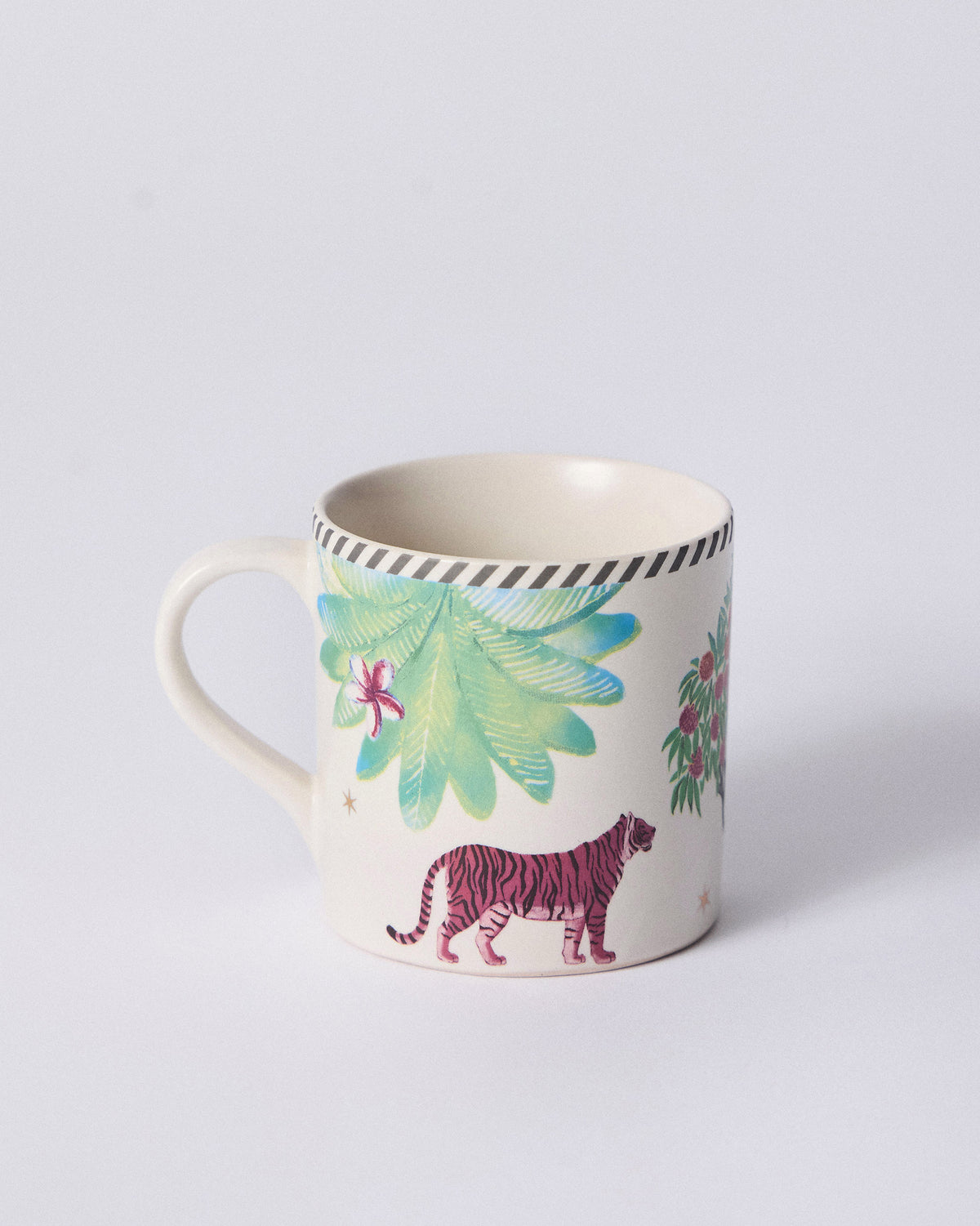 Side view of Ceylon Lush Straight Mug with a pink tiger walking past palm leaves.