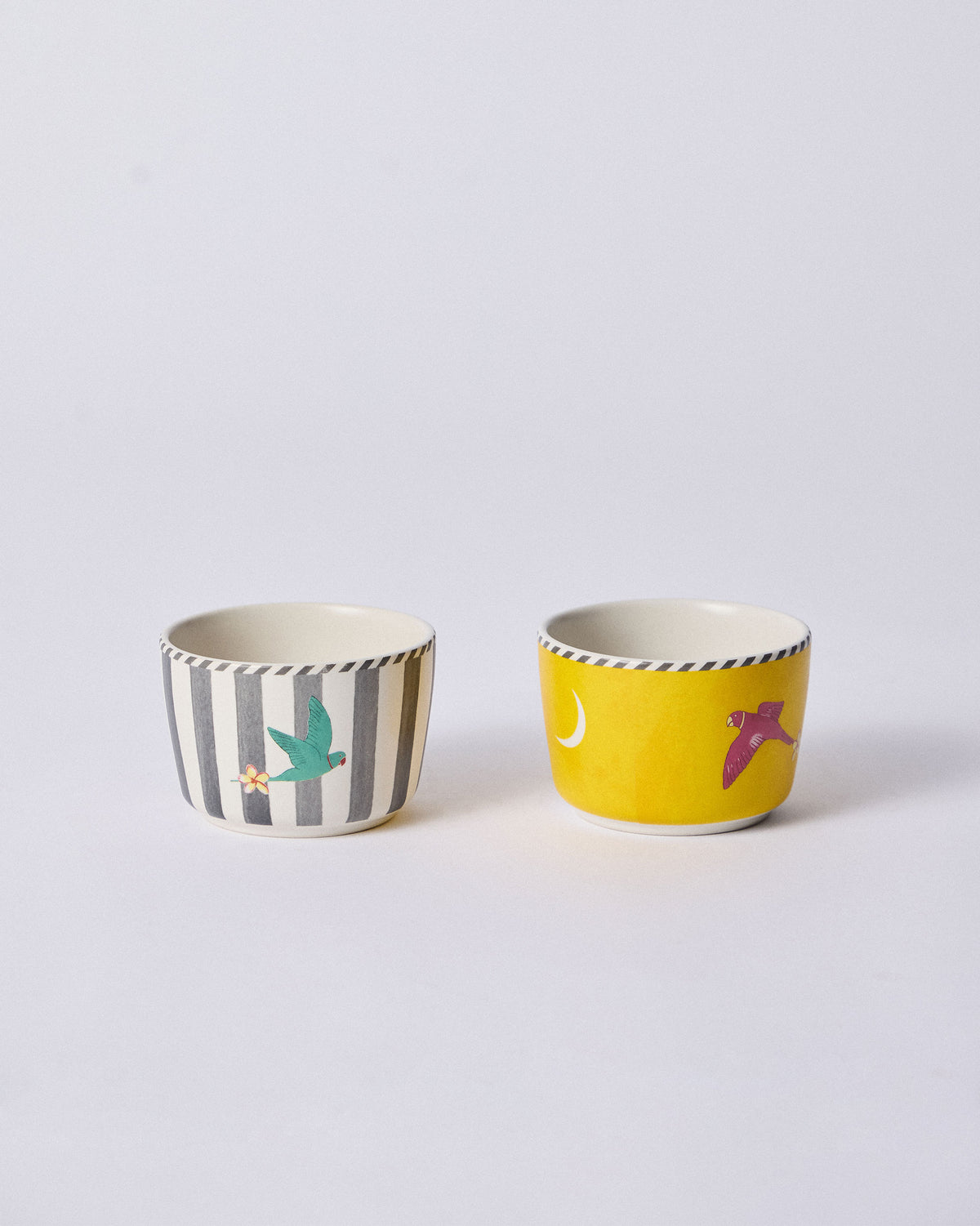 Pair of Ceylon Trail Nut Bowls with striped and yellow bird designs.