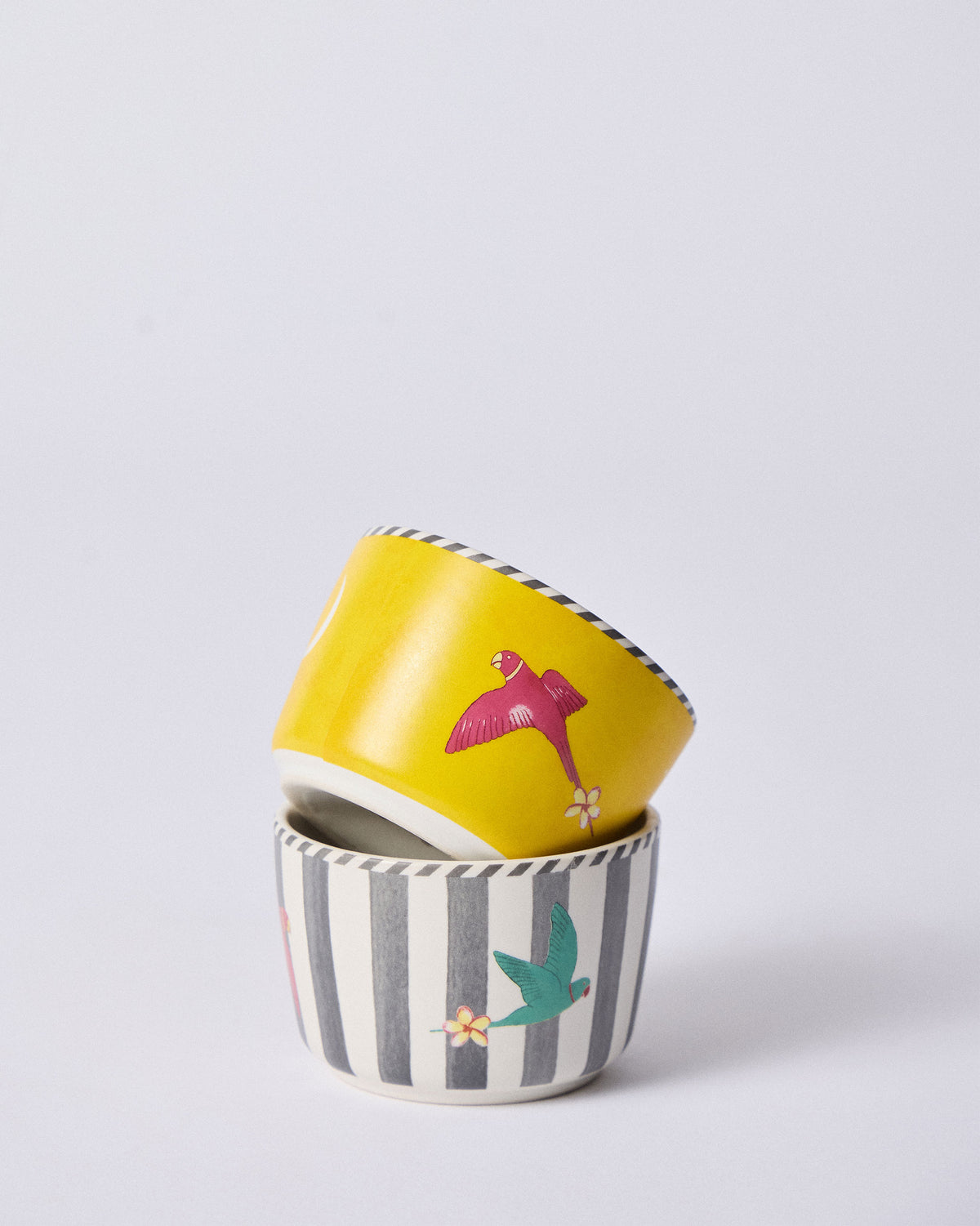 Stacked Ceylon Trail Nut Bowls in yellow and grey-striped bird prints.
