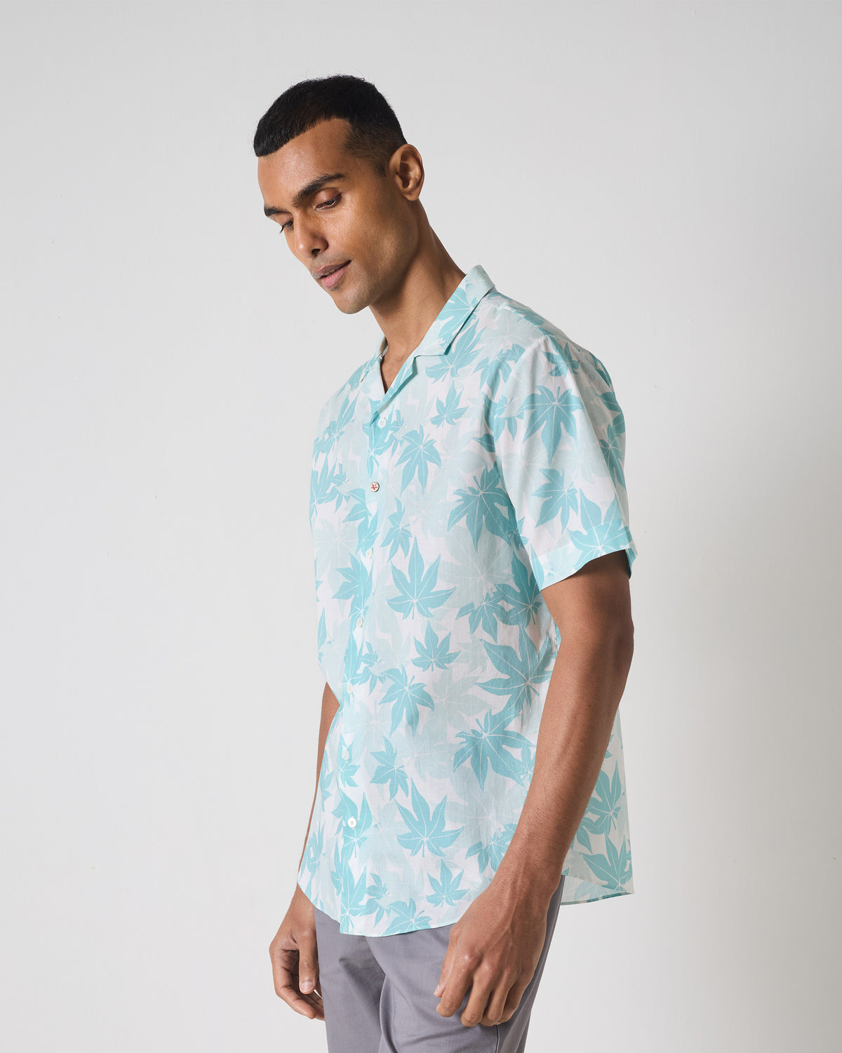Light blue Mistari shirt with leaf print worn at a three-quarter angle.