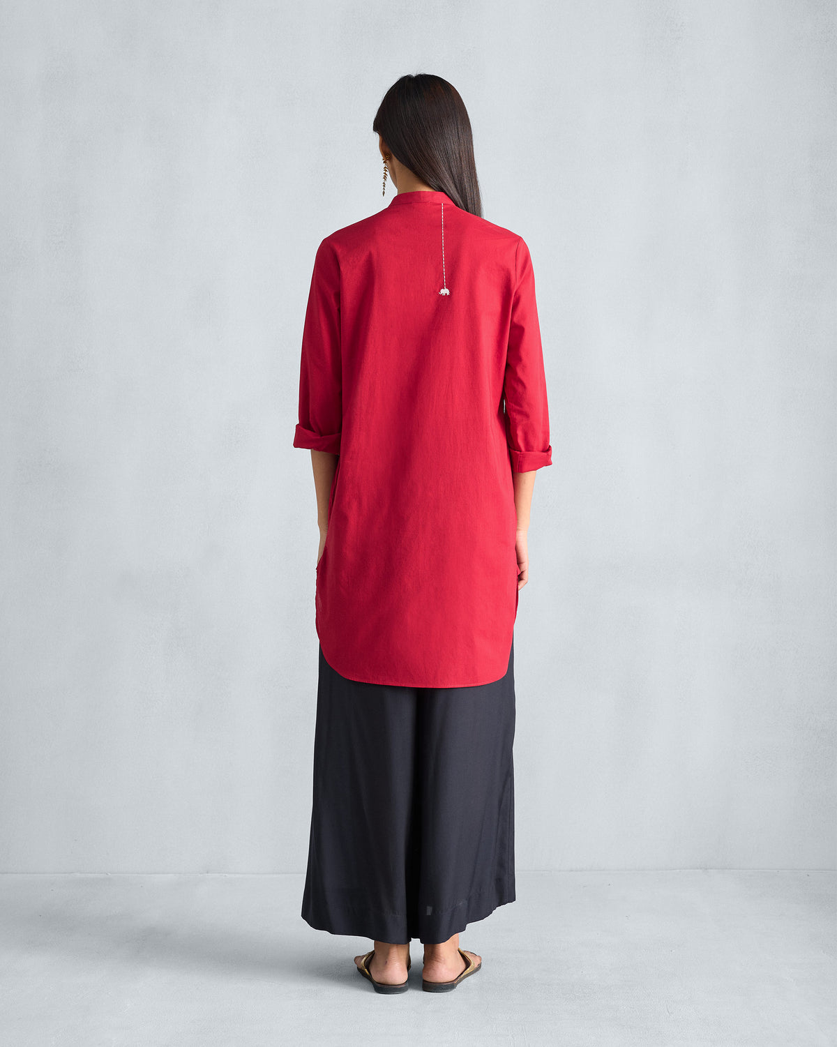 Back of a red mid-length kurta with a curved hem.