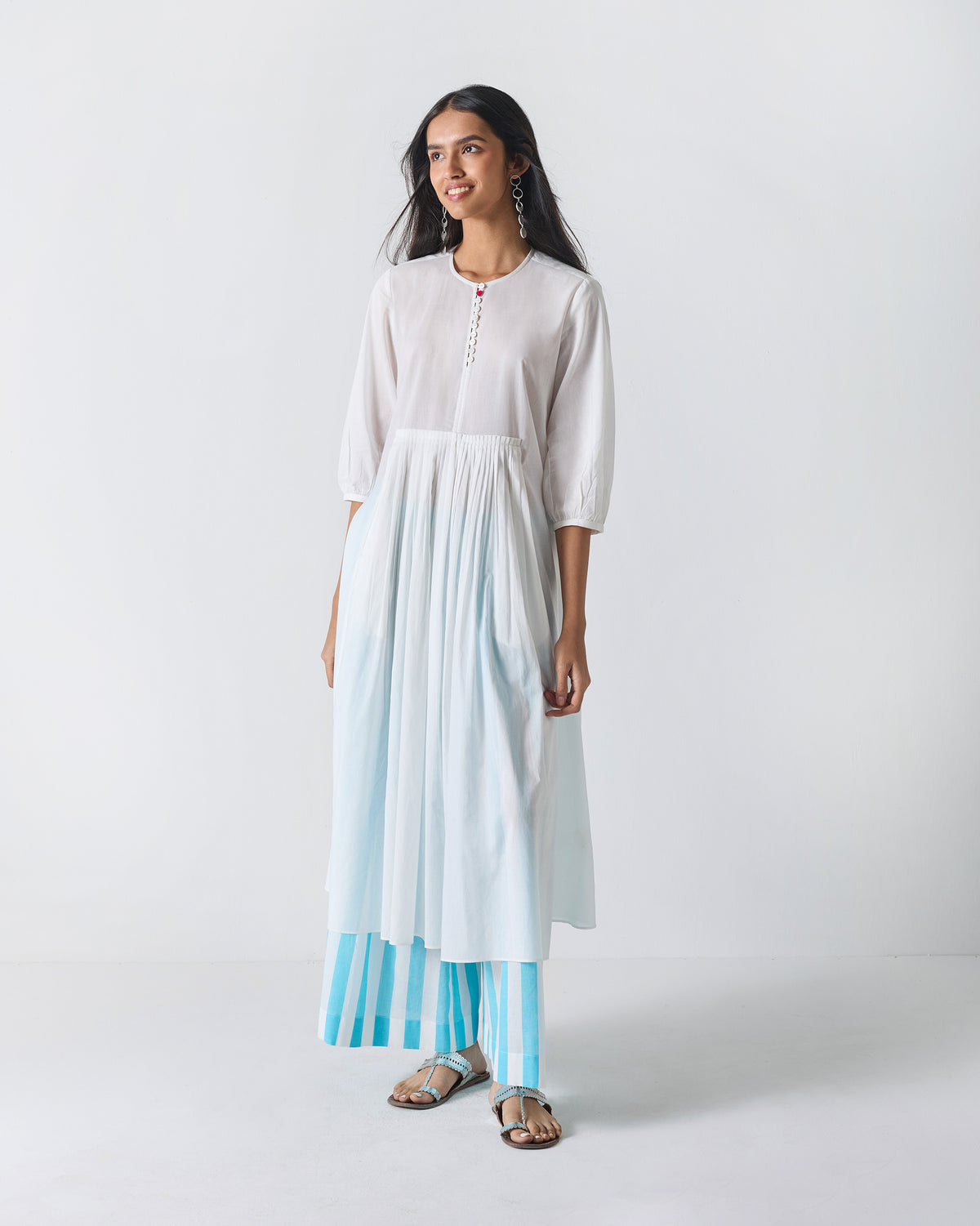 Person wearing a white Pleated Waist kurta with three-quarter sleeves and soft pleats.