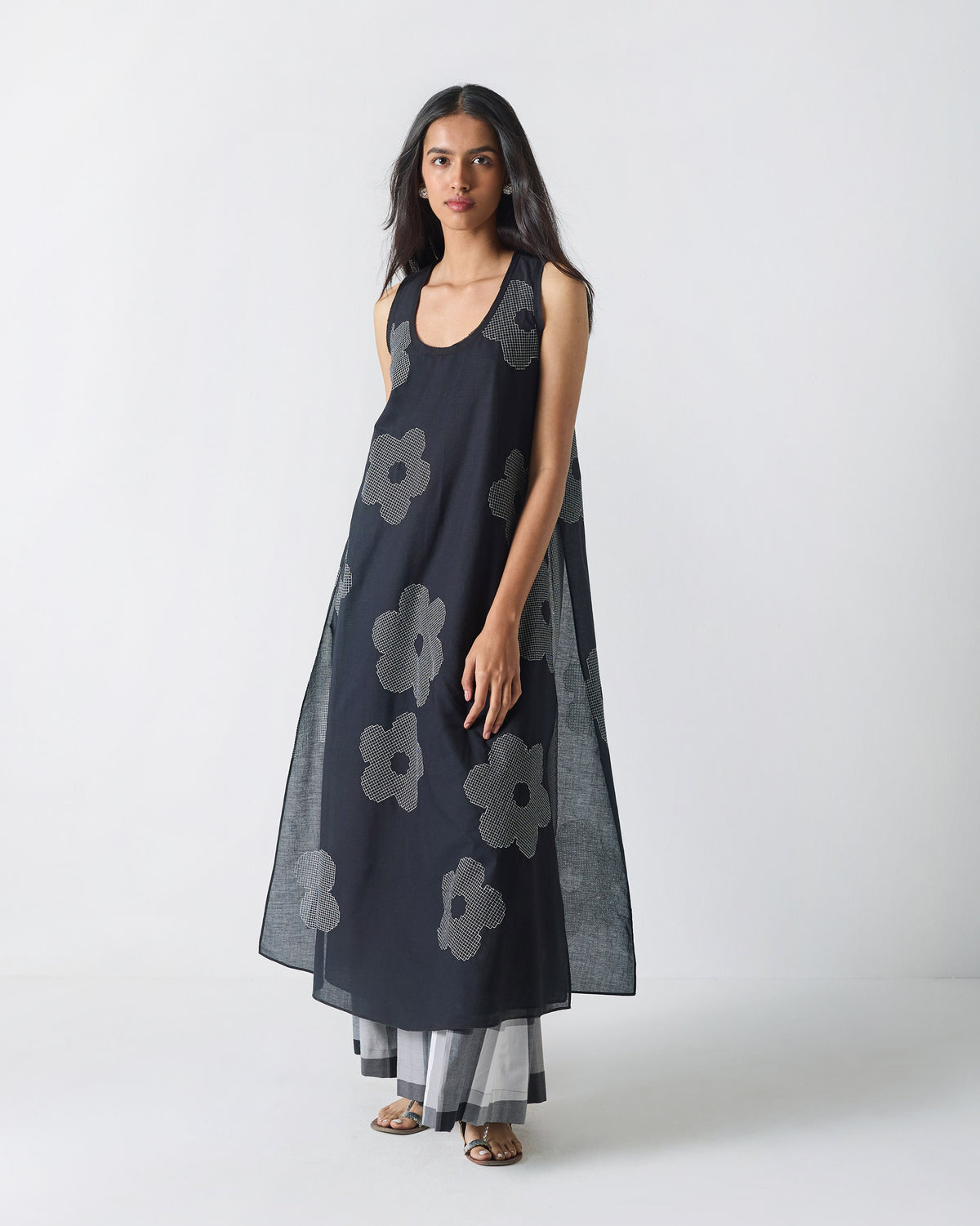 Person wearing a black Double Layer Kurta with white flower embroidery.