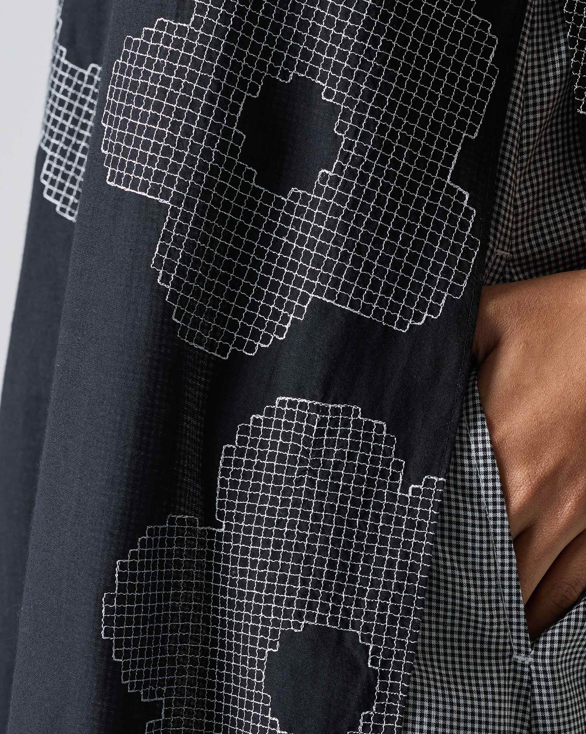 Close-up of a black Double Layer Kurta with white flower embroidery.