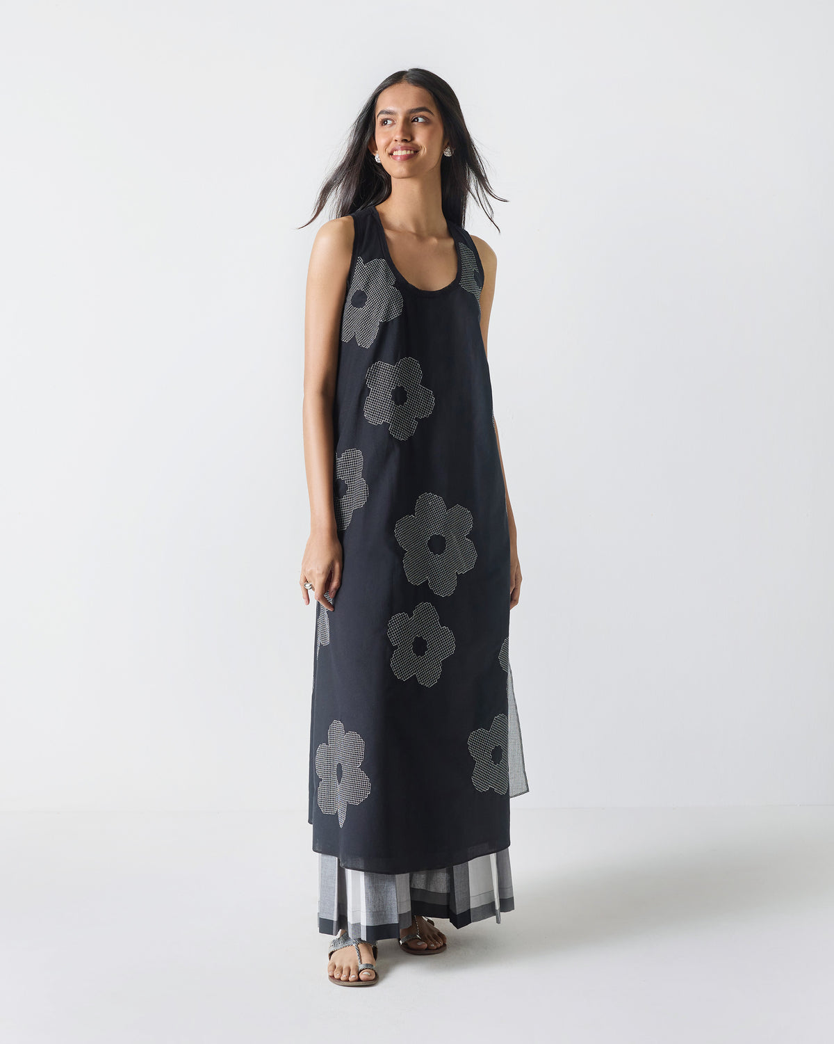 Person wearing a black Double Layer Kurta with white flower embroidery.