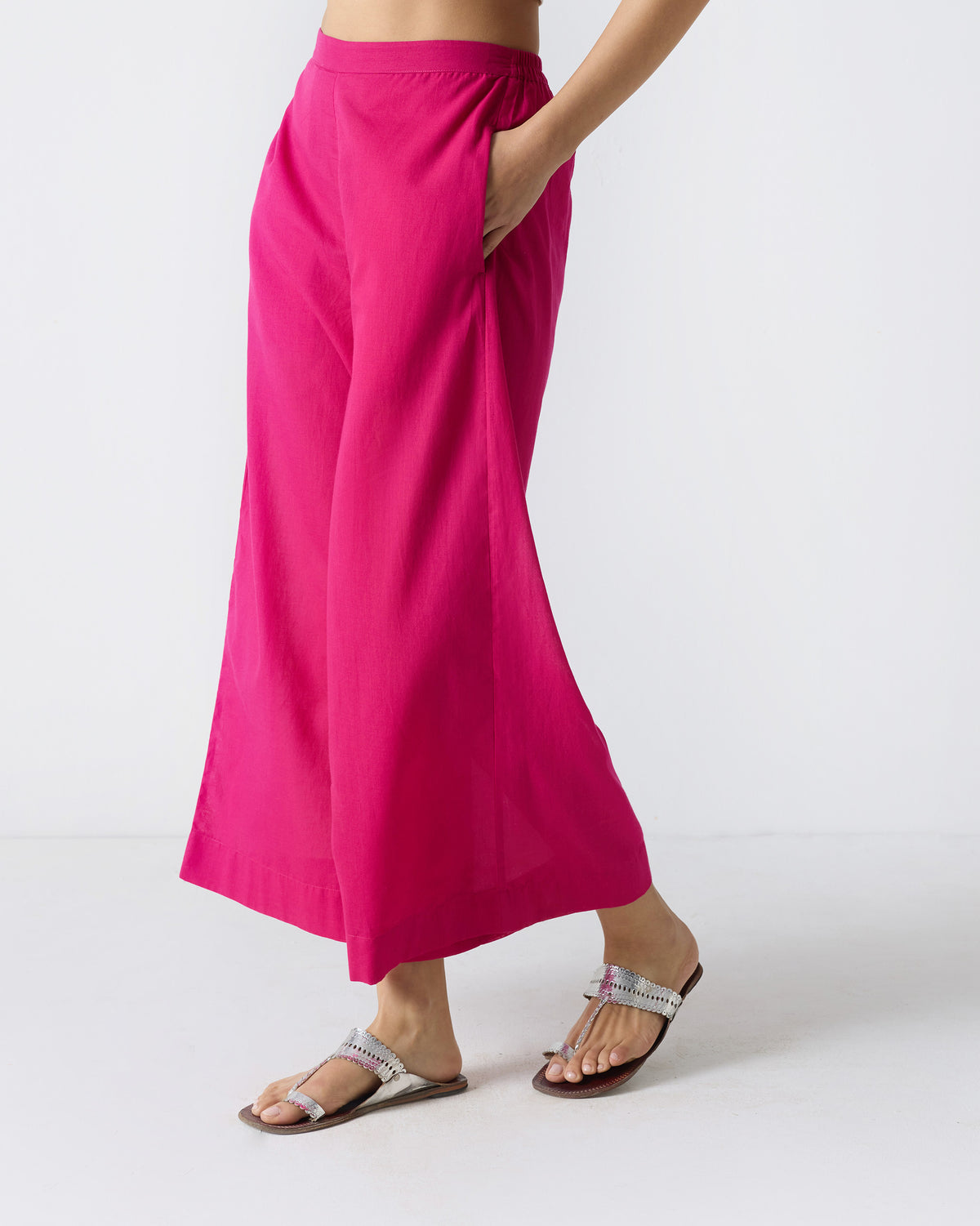 Angled view of fuchsia wide-leg Basic Pyjamas with an elastic waist.