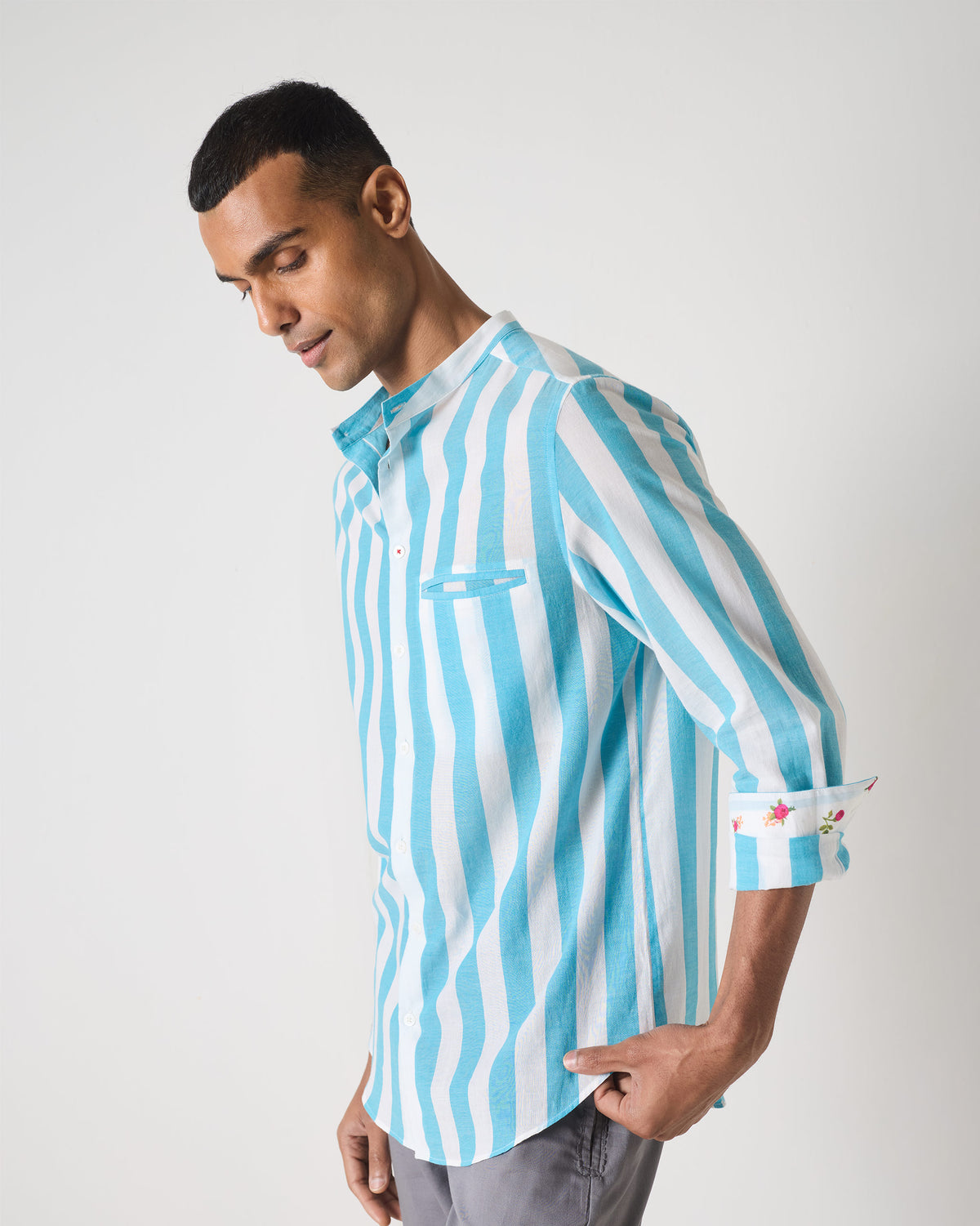 Blue striped Slim Fit Shirt with floral embroidered cuff lining.